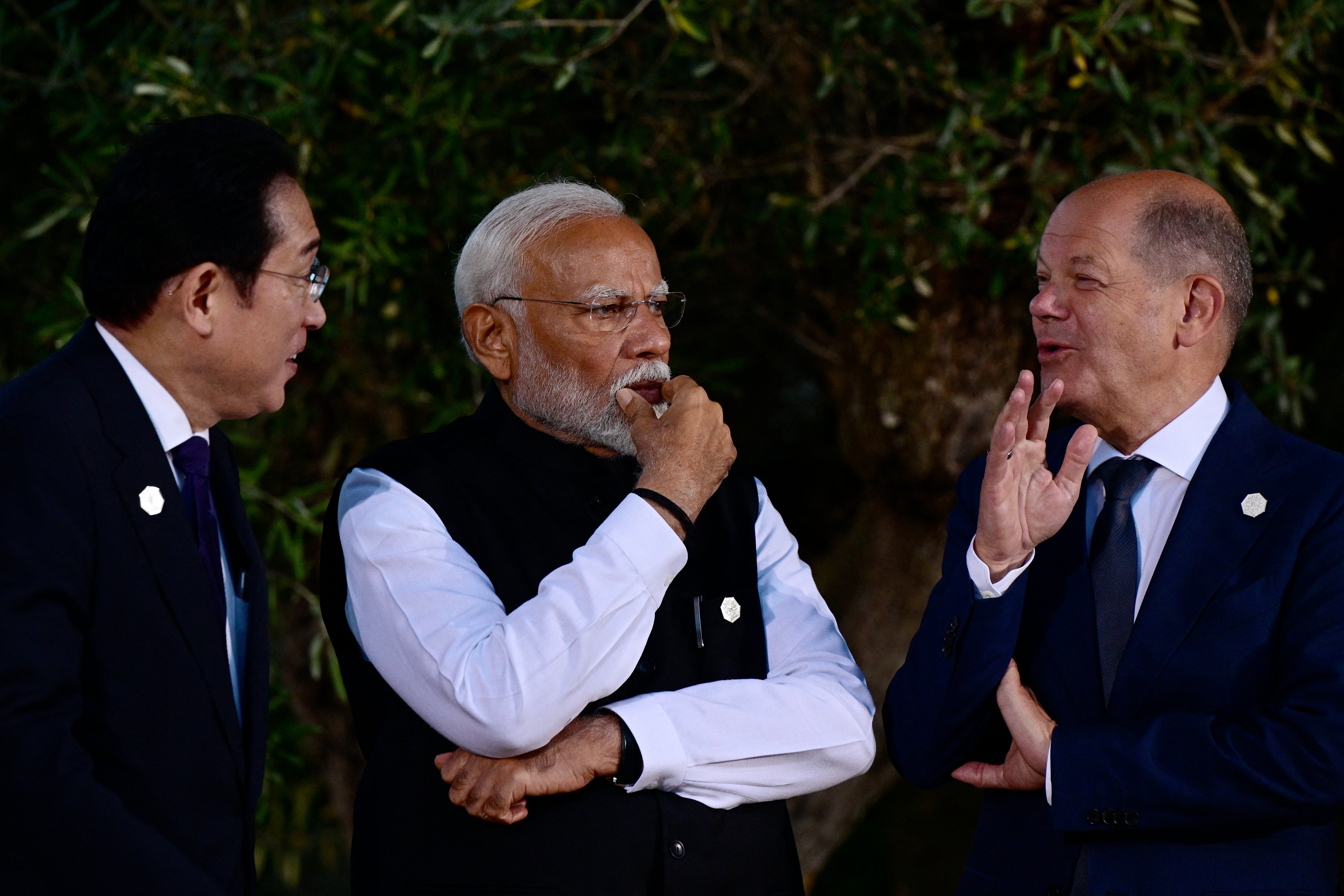 Japanese Prime Minister Fumio Kishida (L), Indian Prime Minister Narendra Modi and German Chancellor Olaf Scholz (R) chat before a family photo with G7 heads of the states