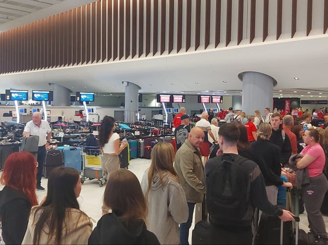 <p>Power cut: Passengers at Manchester airport Terminal 2 on Sunday morning </p>