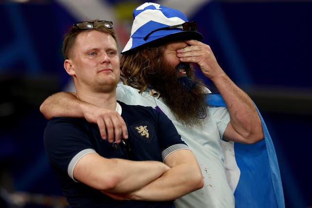 <p>Dejected fans of Scotland after their Euro 2024 exit</p>