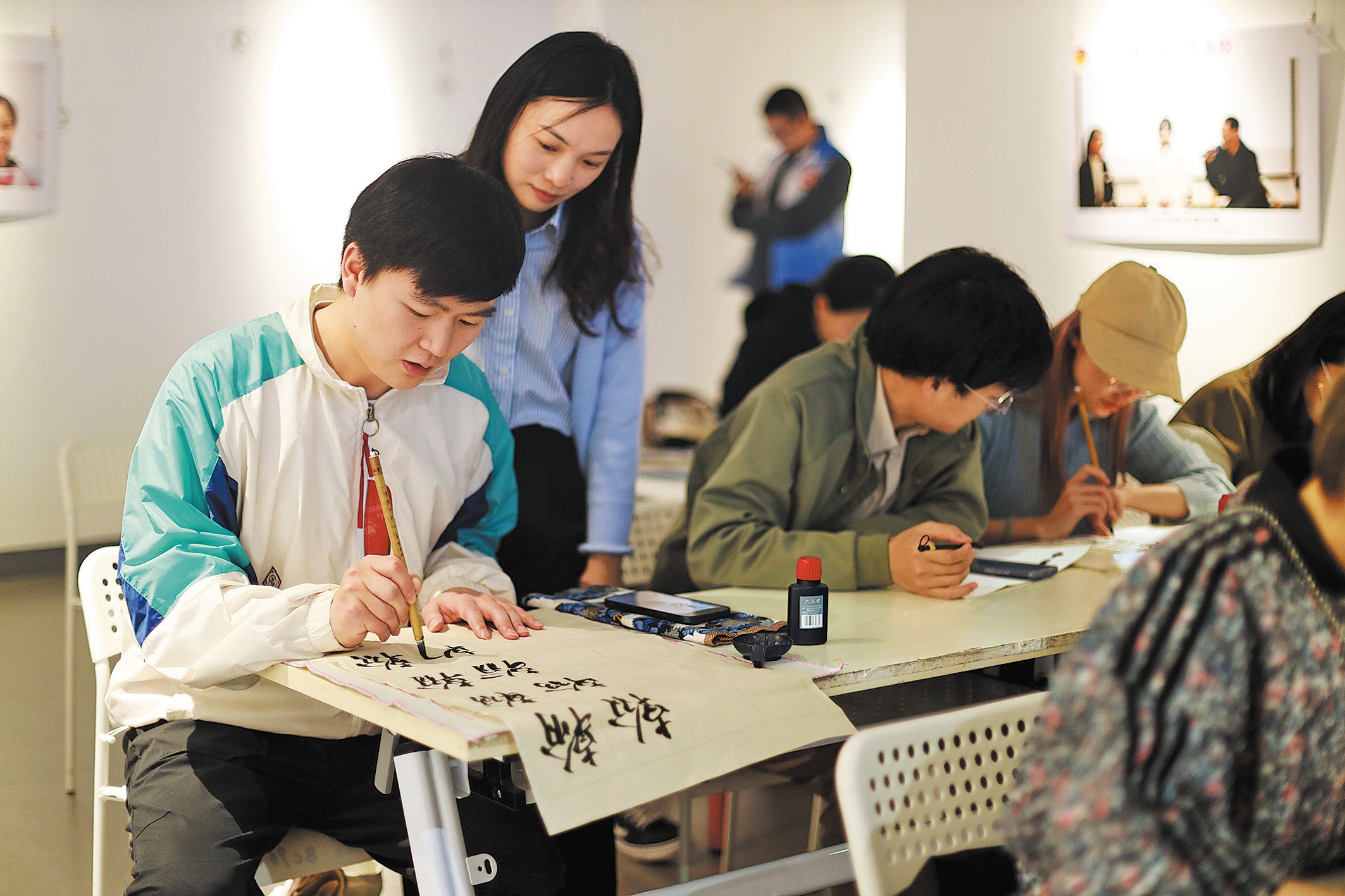 Students practise calligraphy at Guanyinqiao Night School in Chongqing in April