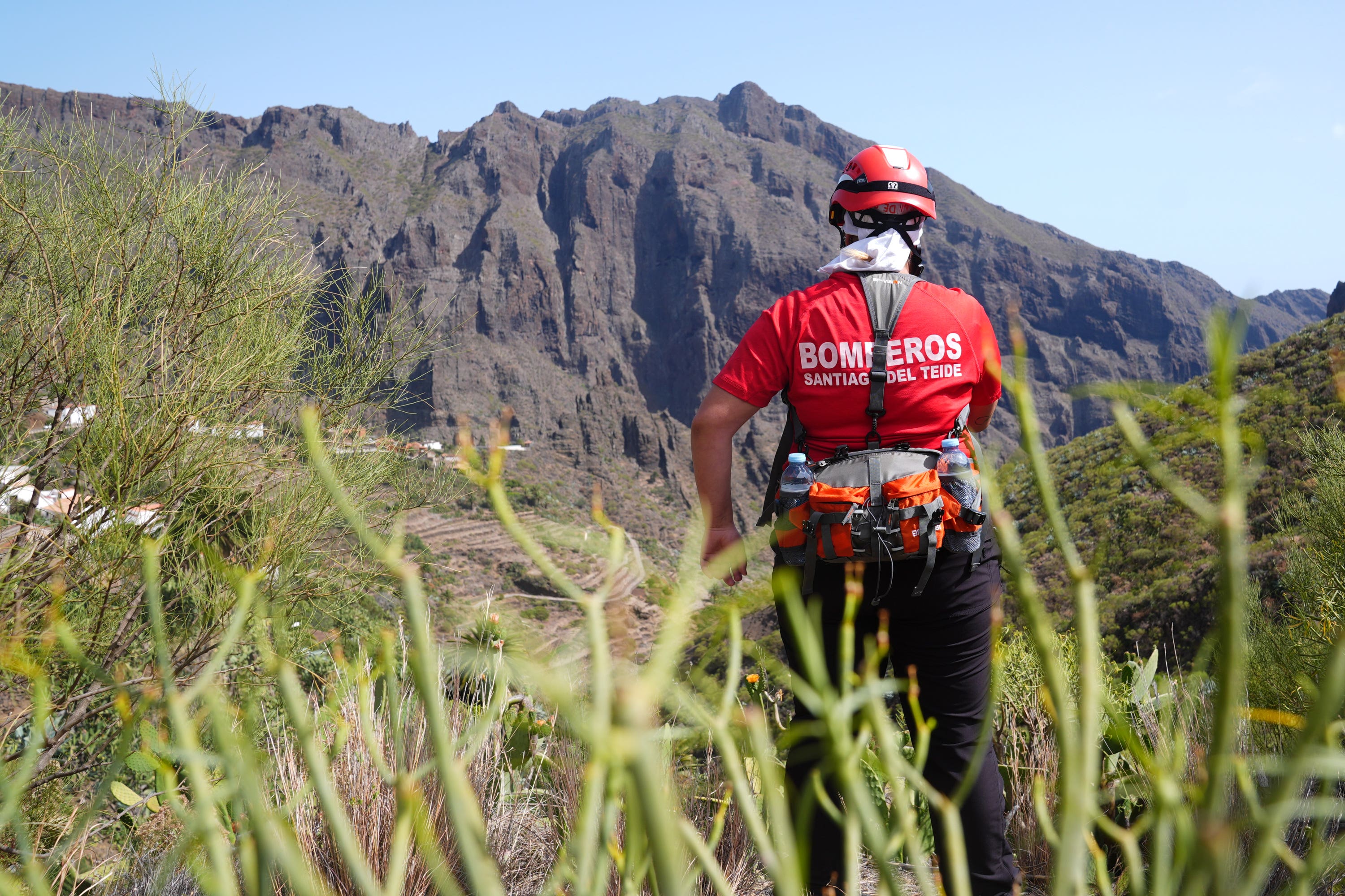 A firefighter looks over the village of Masca, Tenerife, where the search for missing British teenager Jay Slater, 19, continues (James Manning/PA)