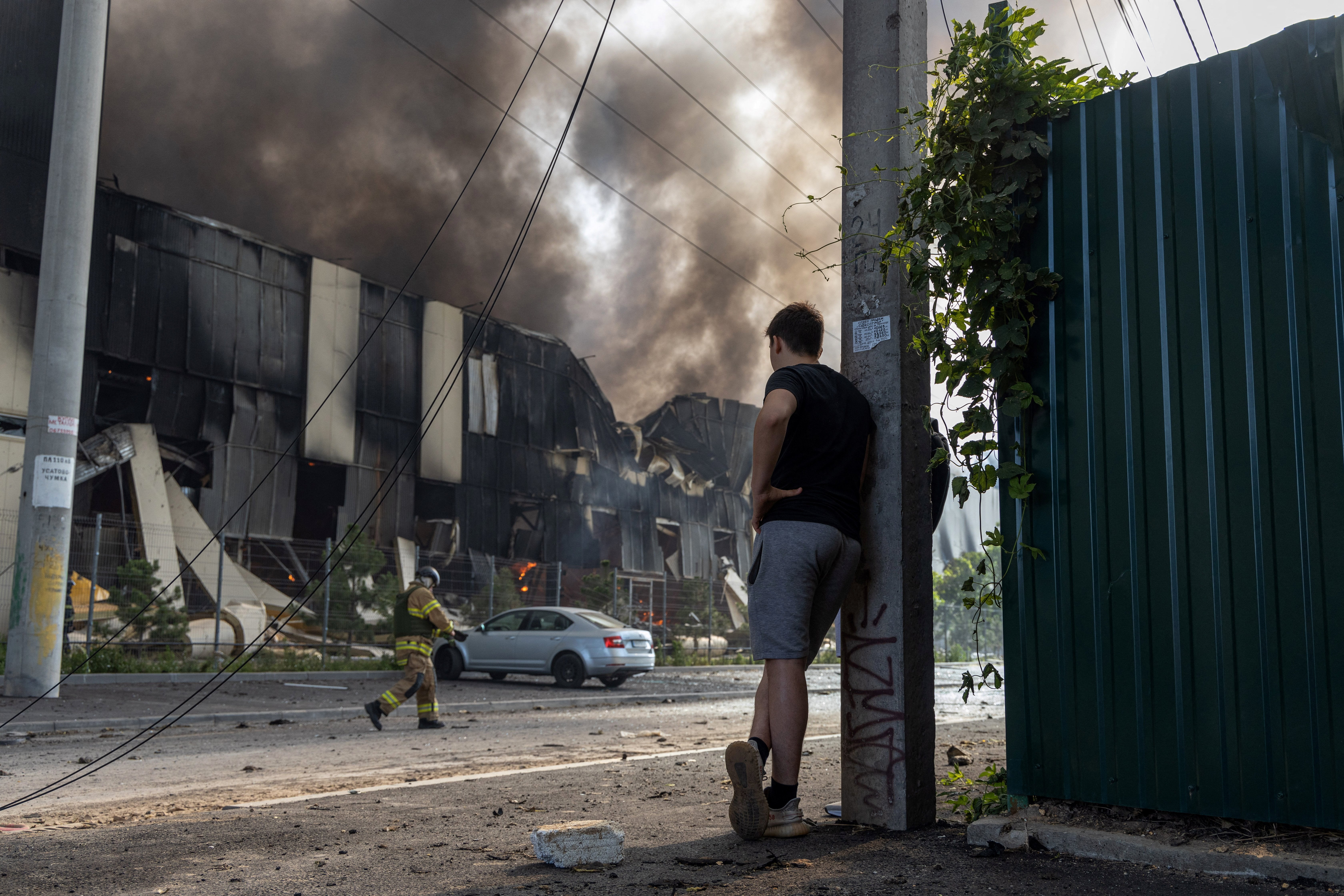 Firefighters work to extinguish a blaze at the site of a Russian missile strike in Odesa, Ukraine