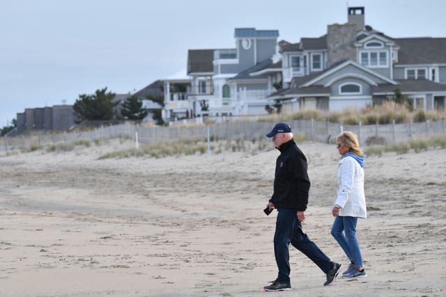 <p>US President Joe Biden and First Lady Jill Biden walk on Rehoboth Beach, Delaware on November 7, 2021</p>