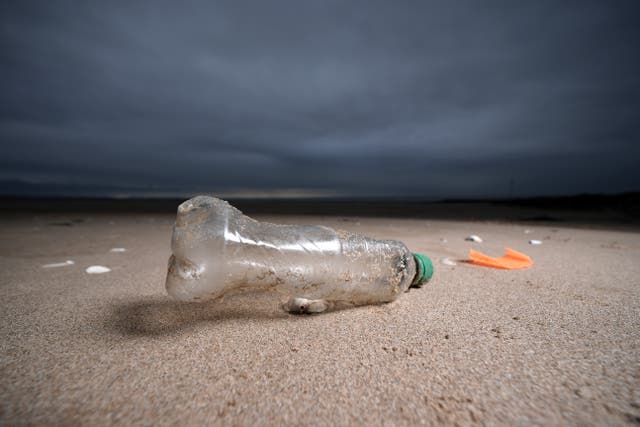 <p>A plastic bottle and the remains of a child’s spade lay on the beach on Earth Day in North Wales on April 22, 2024 in Prestatyn, United Kingdom</p>