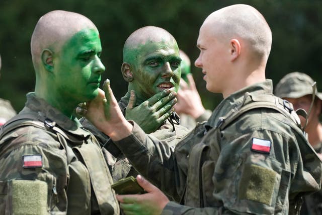 <p>Volunteers in Poland's army learn to apply camouflage face paint during basic training in Nowogrod, Poland, on Thursday June 20</p>