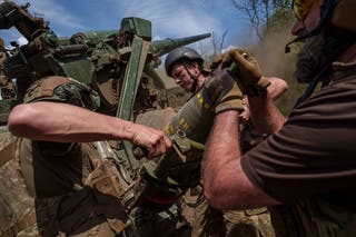 Ukrainian soldiers of 43rd artillery brigade load 203mm shell into 2s7 self-propelled howitzer before firing towards Russian positions at the frontline in Donetsk region