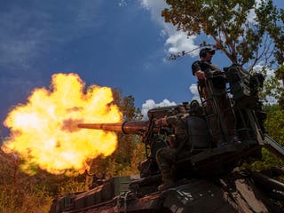 Ukrainian soldiers, of 43rd artillery brigade, fire by 2s7 self-propelled howitzer towards Russian positions at the frontline in Donetsk region