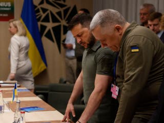 Ukrainian President Volodymyr Zelensky (2nd R) and the Deputy Head of the Office of the President of Ukraine Igor Zhovkva (R) are pictured during a bilateral meeting with the German Chancellor on the sidelines of the Nato Summit in Vilnius, Lithuania, last year