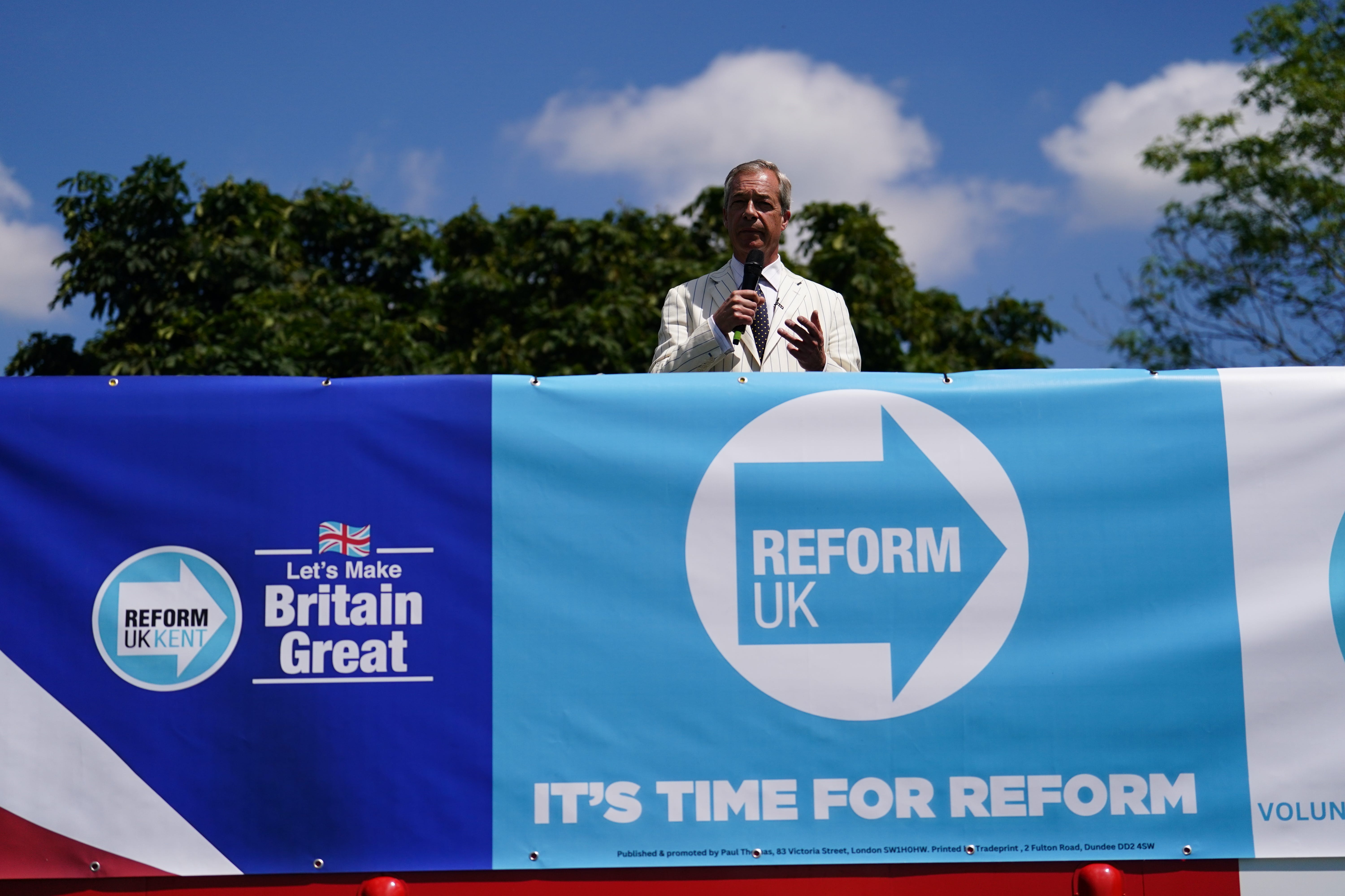 Reform UK leader Nigel Farage speaking on top of a double decker bus in Maidstone, Kent, during the election campaign trail (Jordan Pettitt/PA)