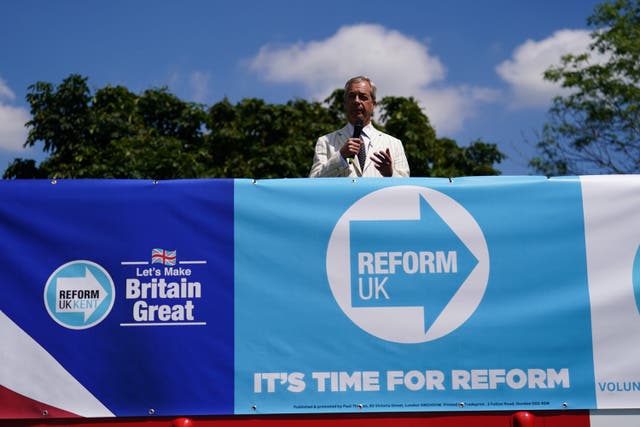 Reform UK leader Nigel Farage speaking on top of a double decker bus in Maidstone, Kent, during the election campaign trail (Jordan Pettitt/PA)