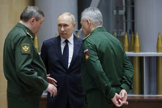 Russian President Vladimir Putin, center, talks with Gen. Valery Gerasimov, left, chief of the General Staff, and Defense Minister Sergei Shoigu after a meeting in Moscow, Russia