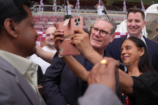 Labour Party leader Sir Keir Starmer (centre right) during a visit to Northampton Town Football Club (Jacob King/PA)