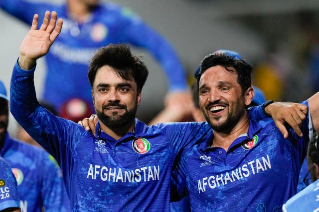 <p>Rashid Khan celebrates Afghanistan reaching World Cup knockout stages</p>