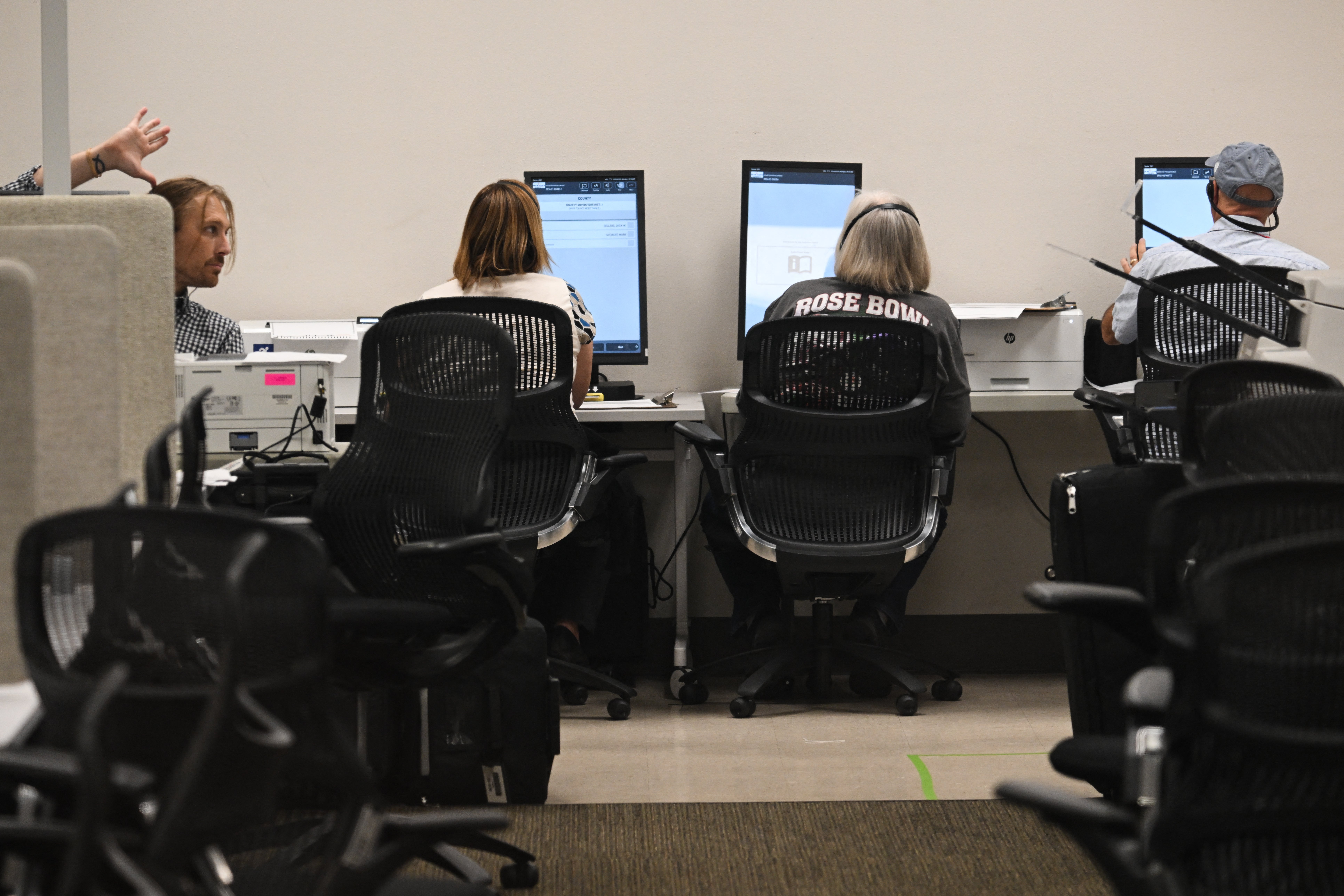 Election workers proofread sample ballots for voters with disabilities in a tabulation room at the Maricopa County Tabulation and Election Center ahead of the 2024 Arizona Primary and General elections in Phoenix on June 3
