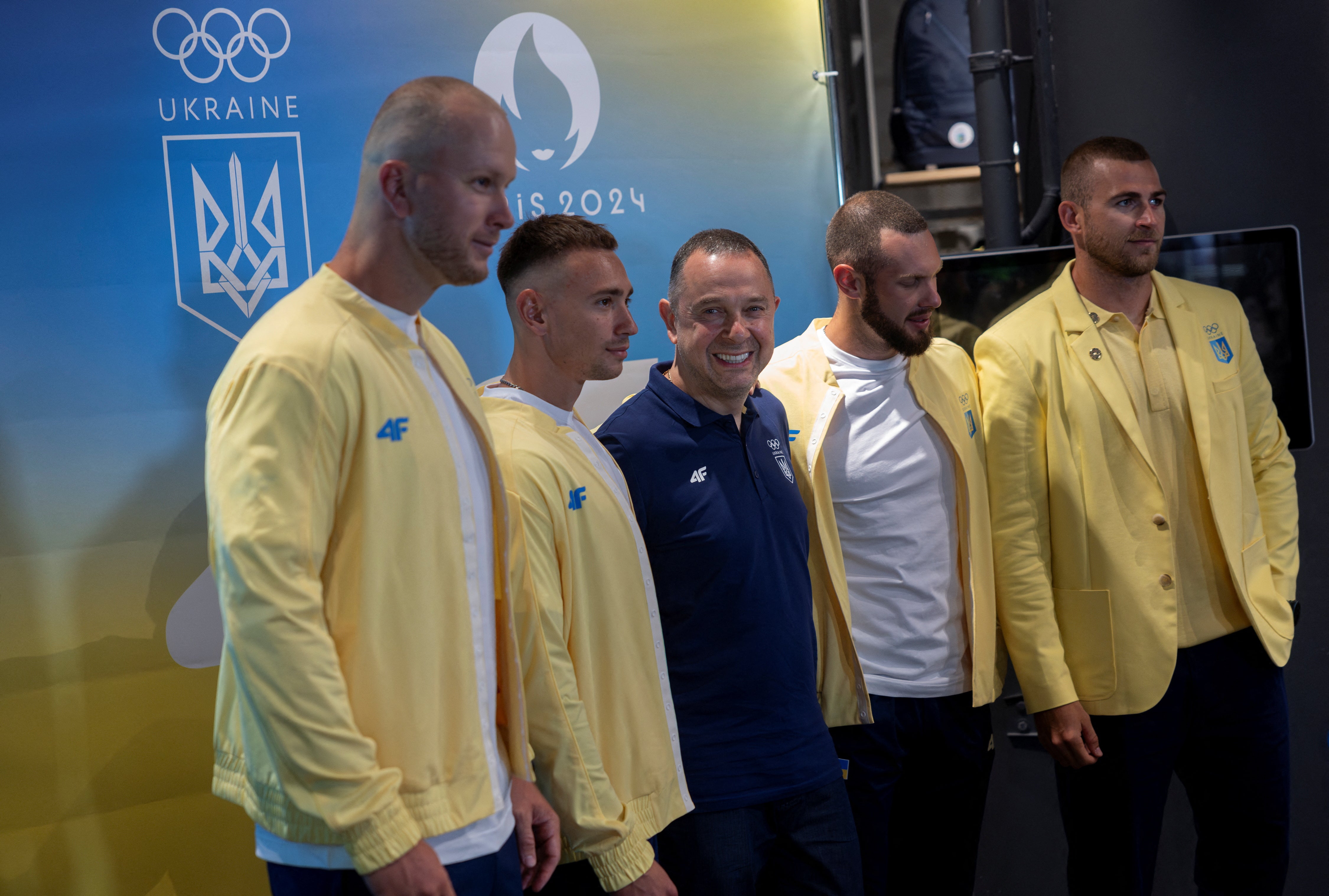 President of the National Olympic Committee of Ukraine Vadym Gutzeit poses for pictures with the kayak four team