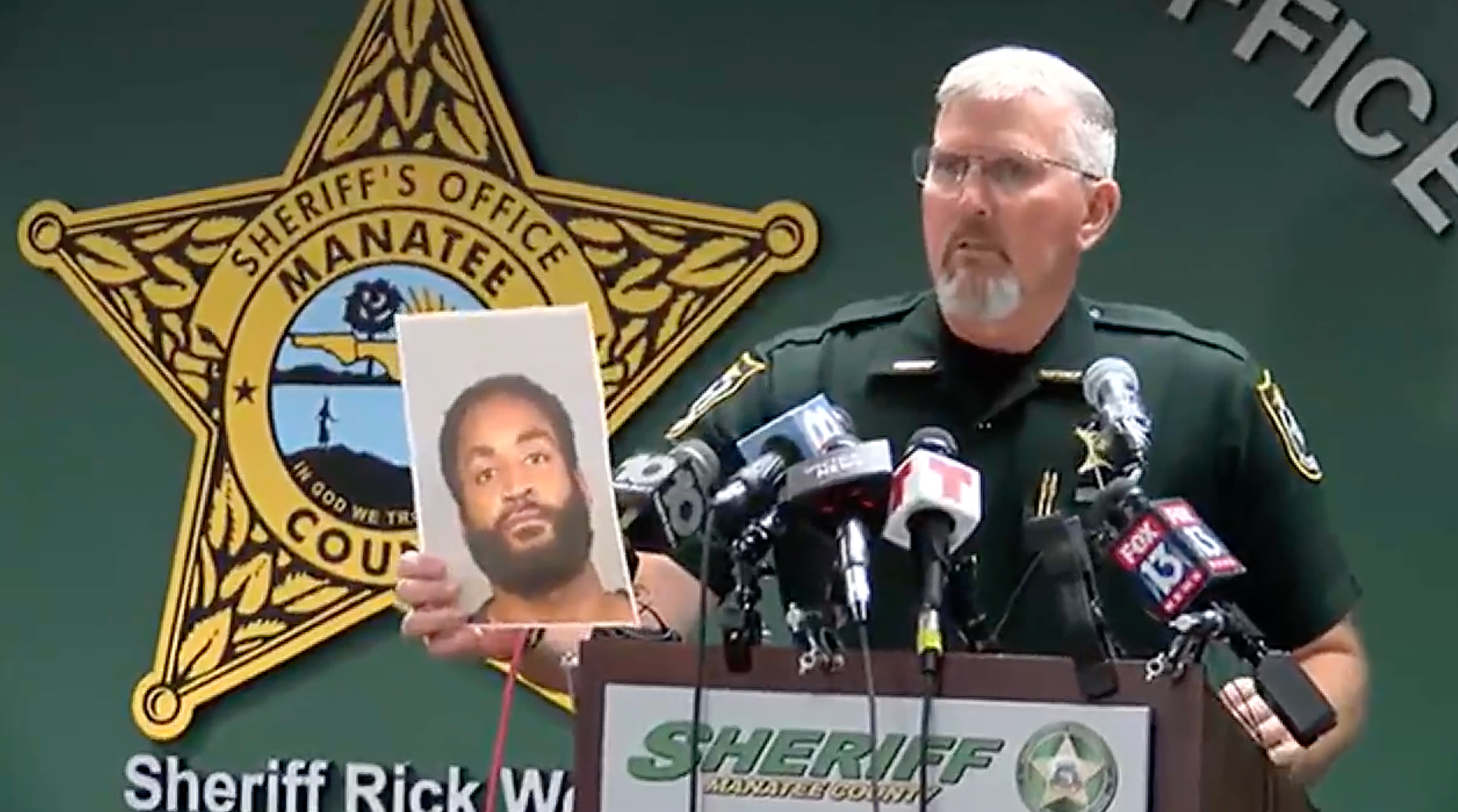 Manatee County Sheriff Rick Wells holds a booking photo of Javontee Brice. While police do not yet have a motive, Wells said Brice’s family has been helpful to investigators.