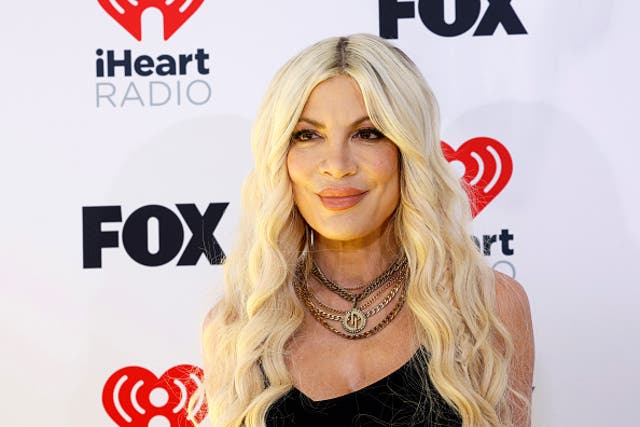 <p>Tori Spelling reveals she received breast implants at 19 within a ‘strip mall’ </p>