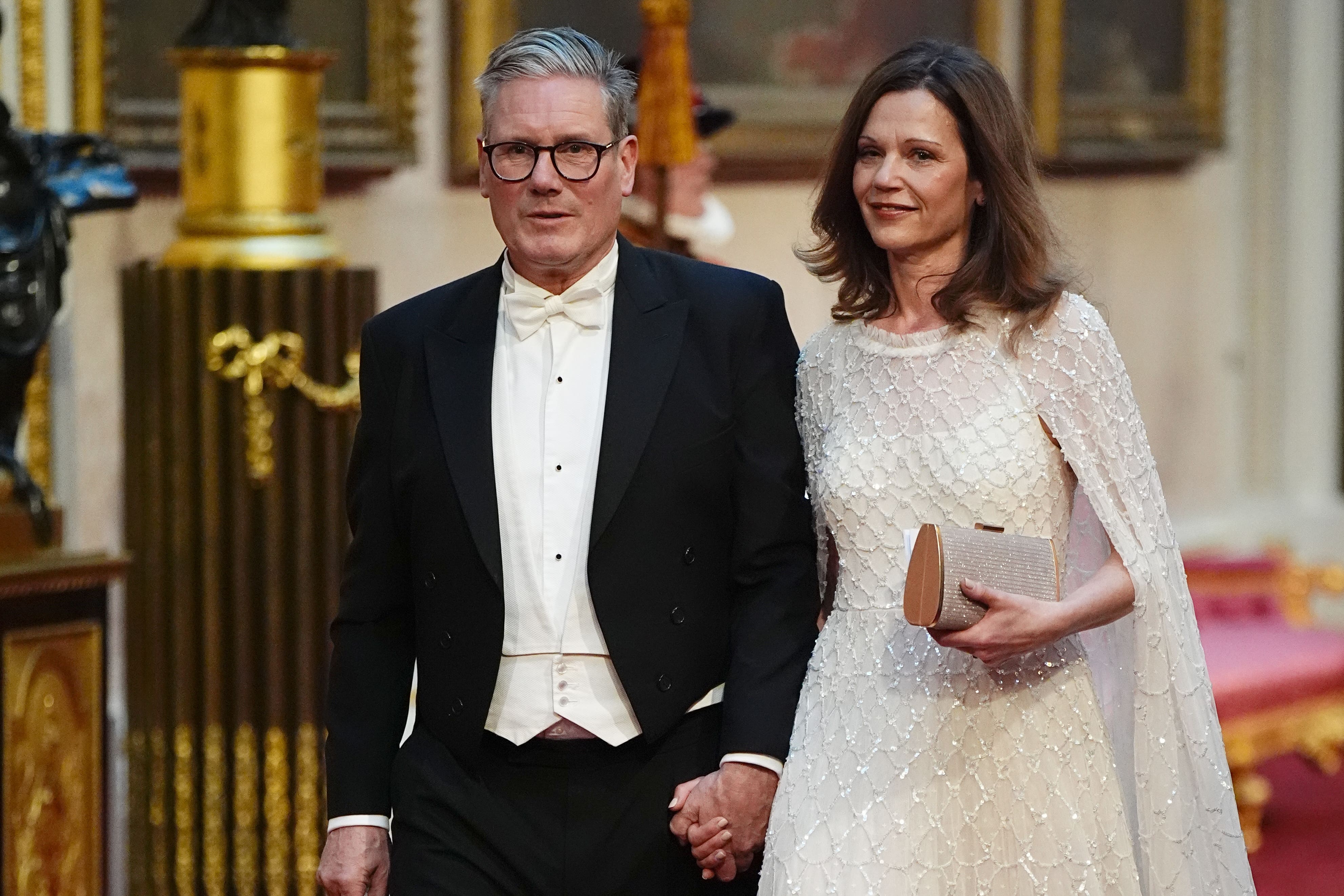 Labour leader Sir Keir Starmer and his wife Victoria make their way along the East Gallery to attend the state banquet for Emperor Naruhito and his wife Empress Masako of Japan at Buckingham Palace (Aaron Chown/PA)