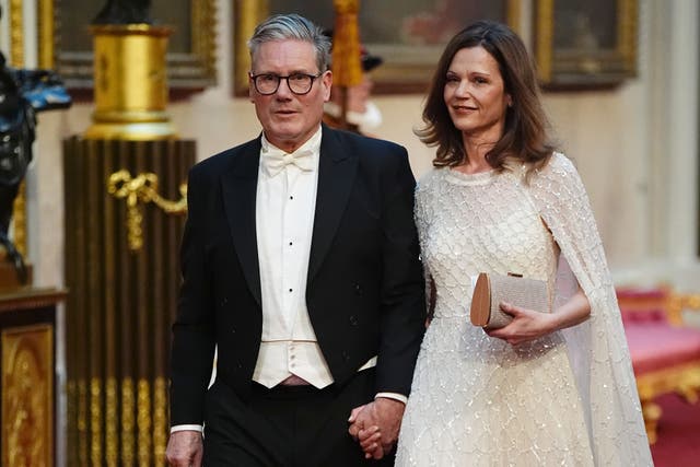 <p>Labour leader Sir Keir Starmer and his wife Victoria make their way along the East Gallery to attend the state banquet for Emperor Naruhito and his wife Empress Masako of Japan at Buckingham Palace (Aaron Chown/PA)</p>