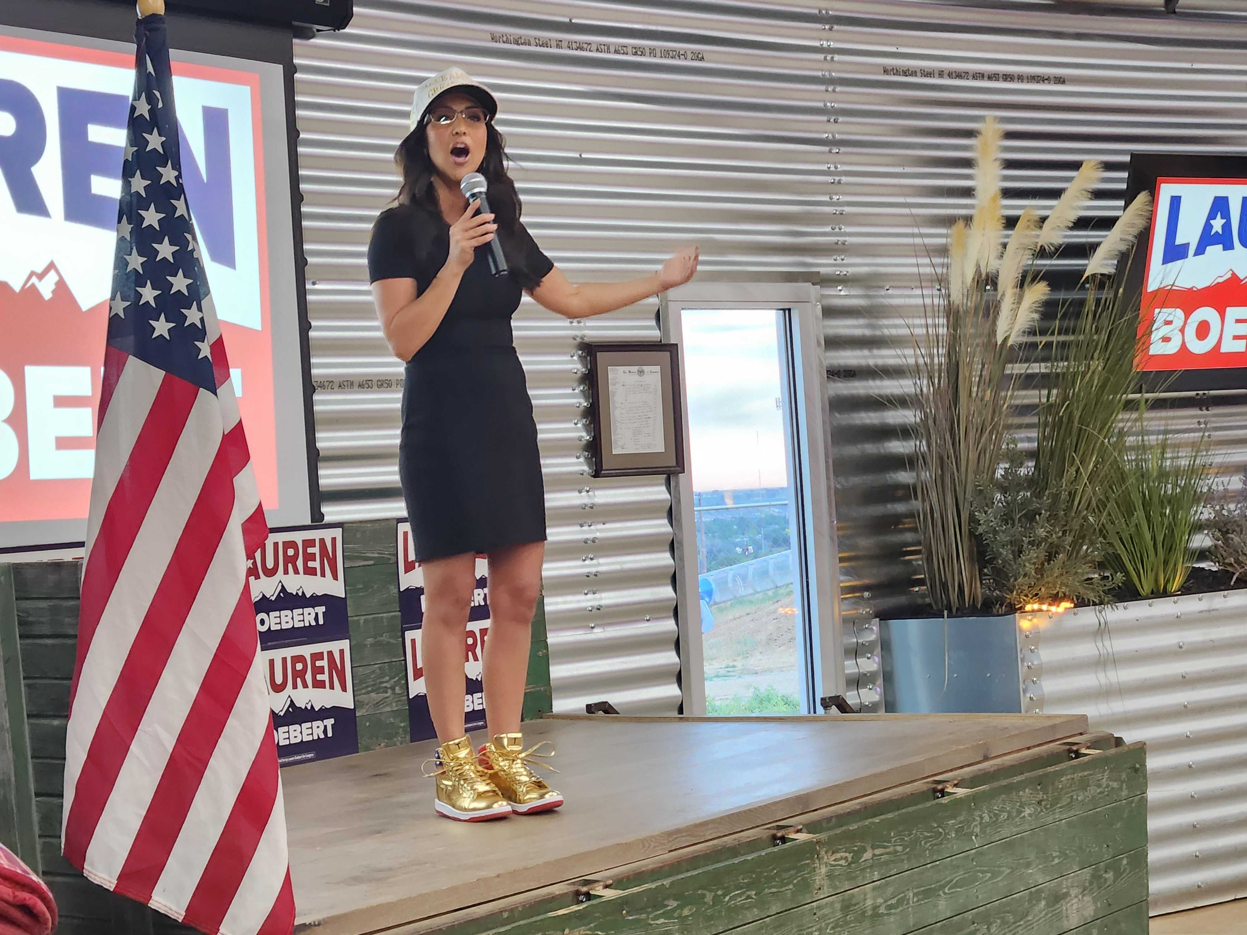 Lauren Boebert, wearing a pair of gold Trump sneakers, speaks to supporters after winning her primary race on June 25 2024