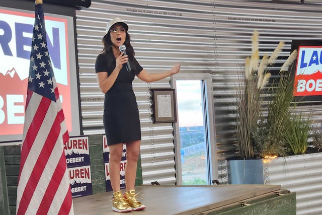 <p>Lauren Boebert, wearing a pair of gold Trump sneakers, speaks to supporters on election night after winning her primary race on June 25, 2024</p>