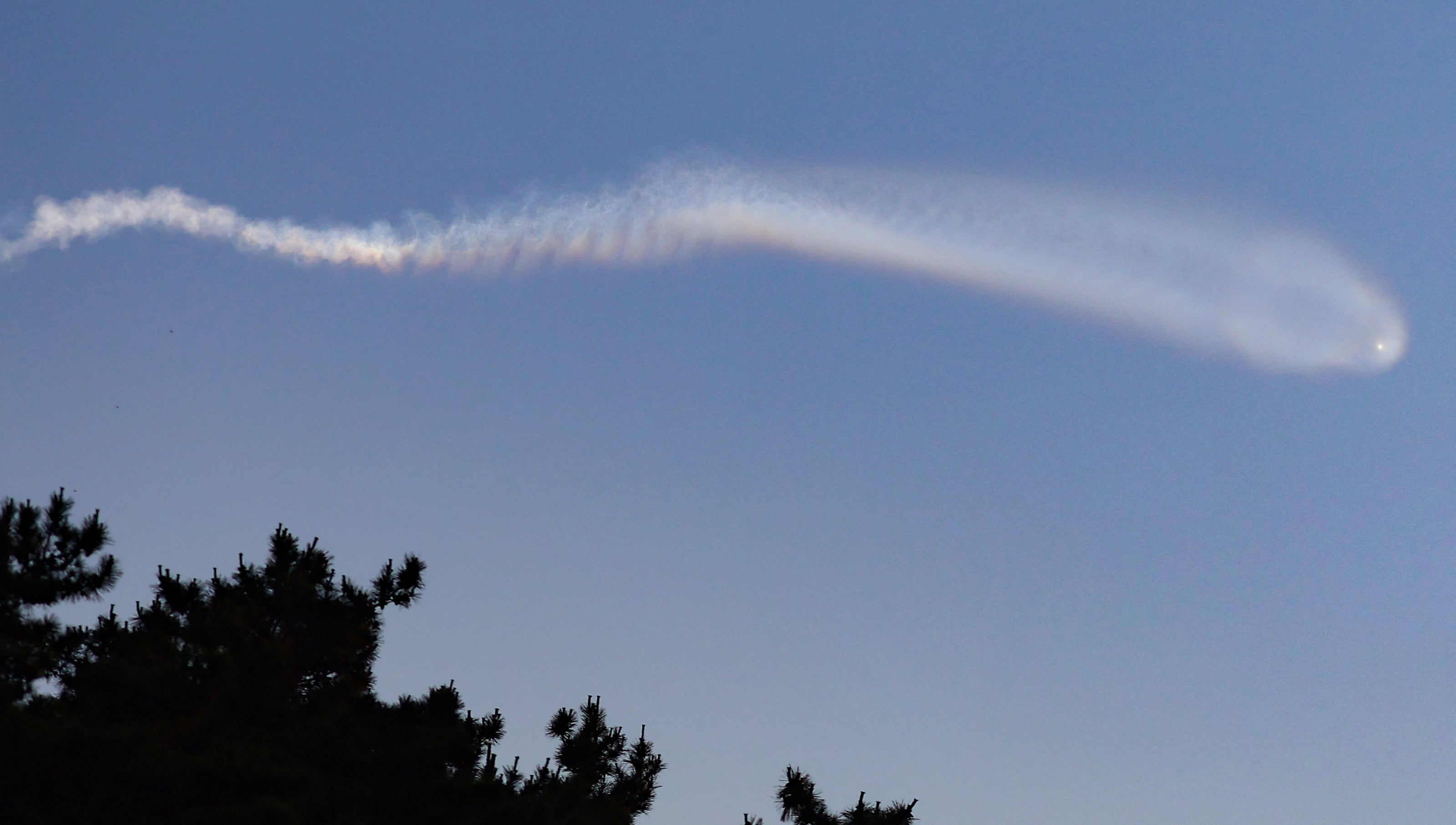 <p>A vapour trail believed to be created by a North Korean ballistic missile is seen from Yeonpyeong island near the 'northern limit line' sea boundary with North Korea </p>
