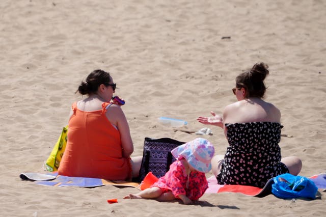 <p>People enjoy the warm weather on Crosby Beach, Merseyside.</p>