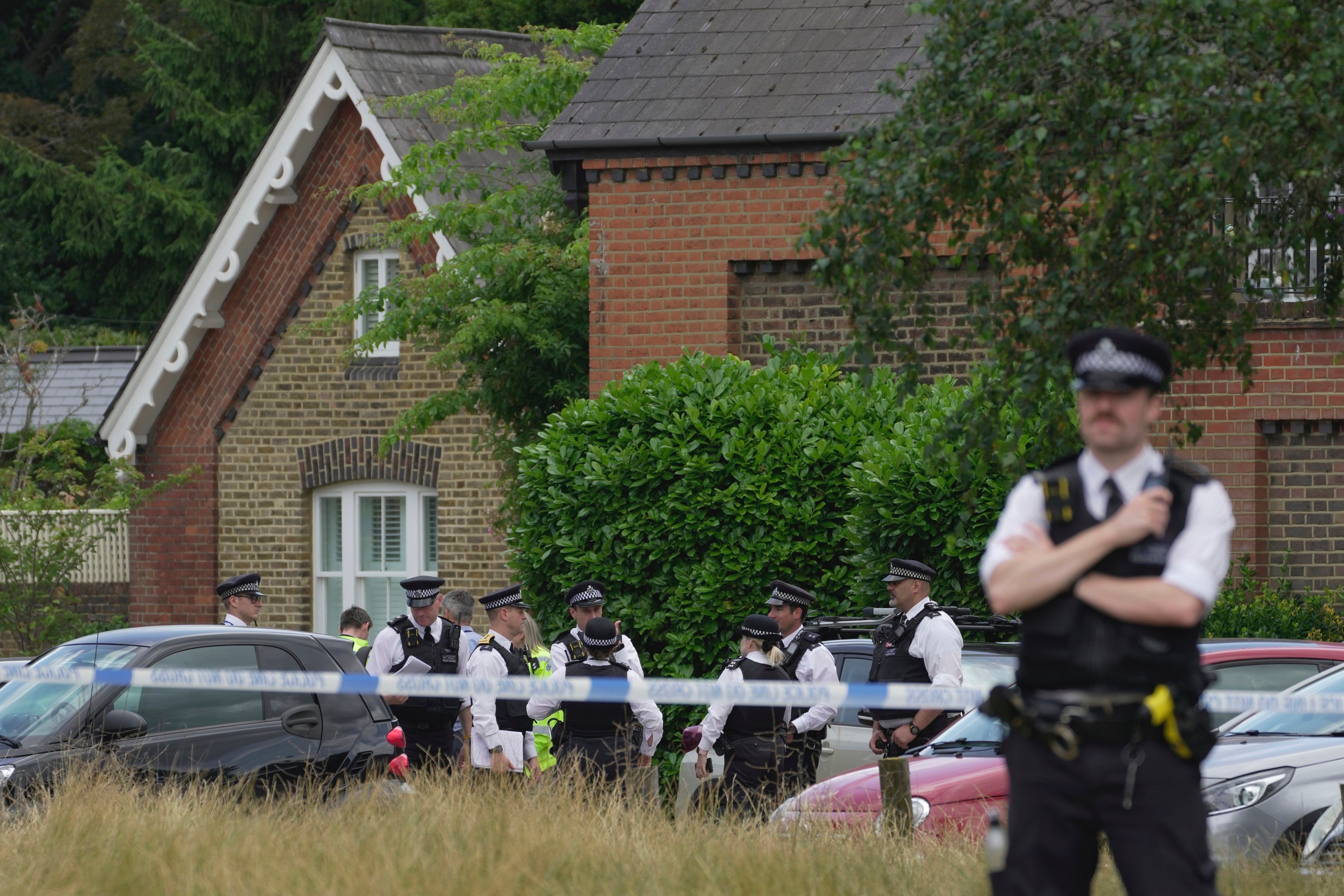 Police officers set up a cordon after the 4x4 crashed into the primary school in Wimbledon, London, in July 2023