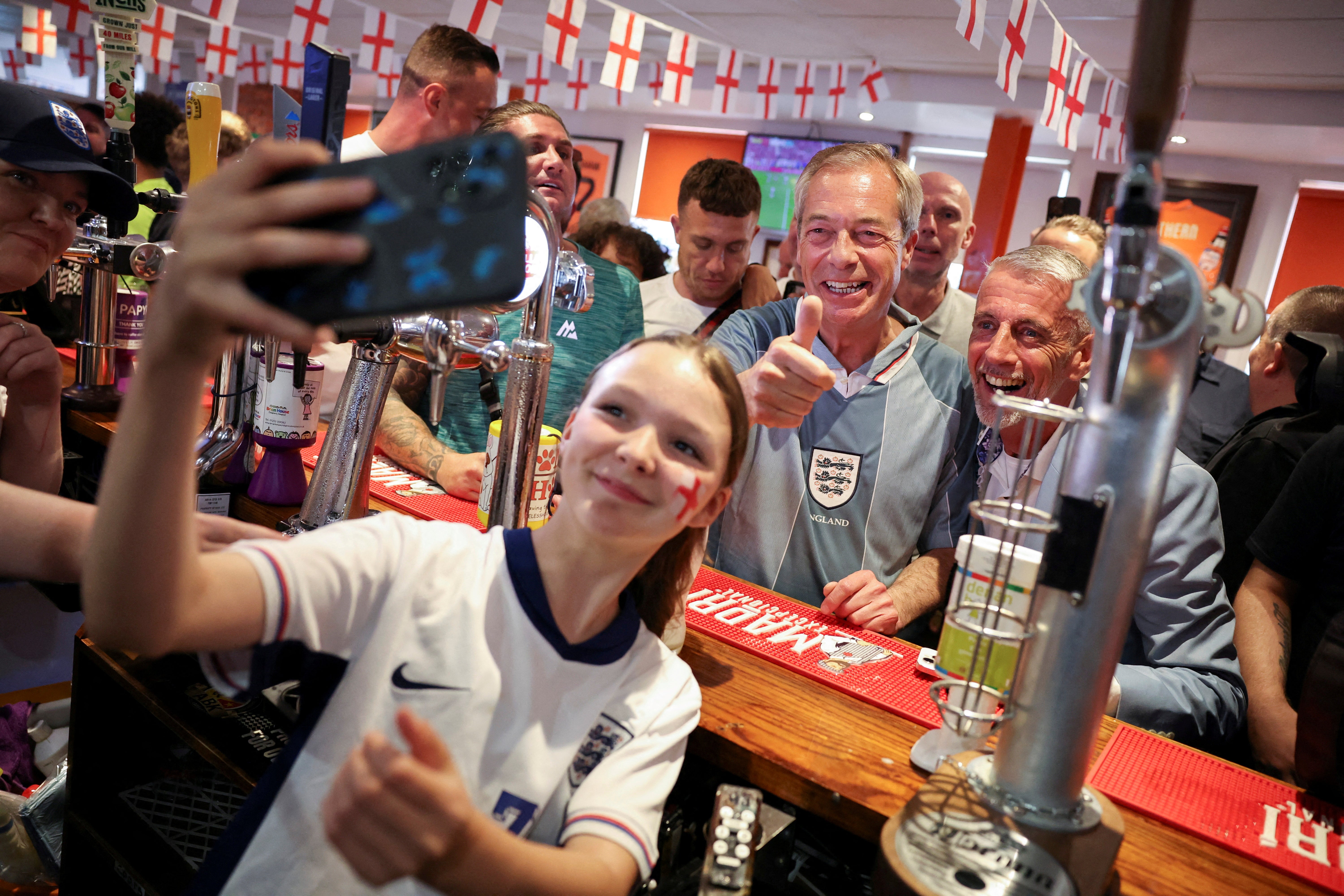 Nigel Farage poses for pictures at a pub in Blackpool before England’s match against Denmark at Euro 2024