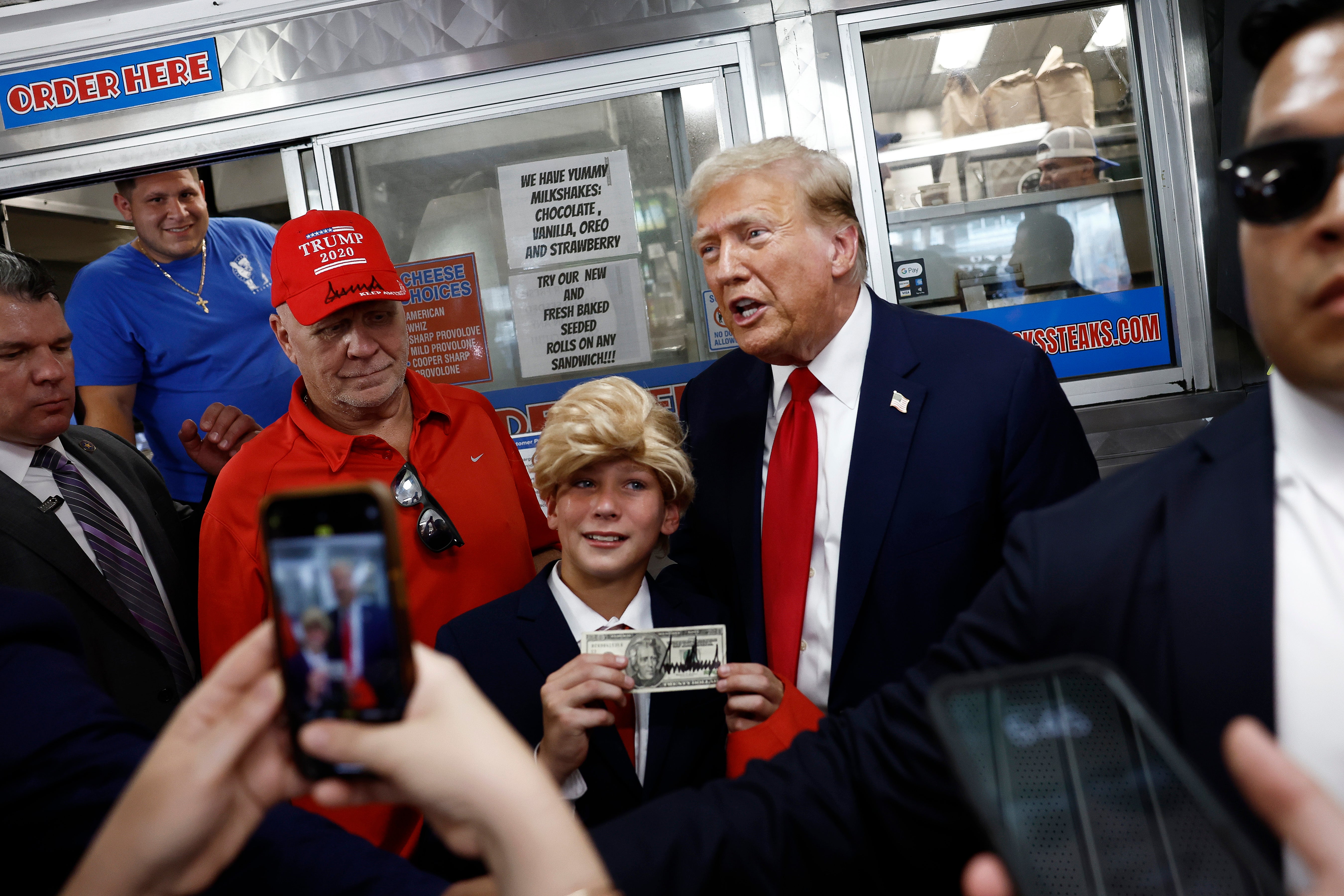 Mini-me: Donald Trump poses with a young fan at a sandwich shop in Philadelphia earlier this month