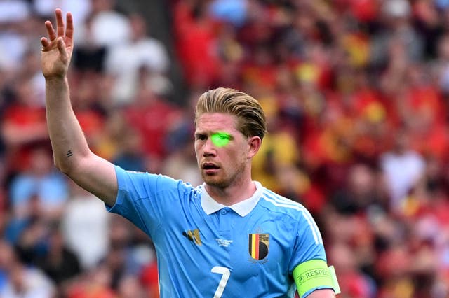 <p>Kevin De Bruyne is distracted by a laser pointer in Belgium’s draw with Ukraine</p>