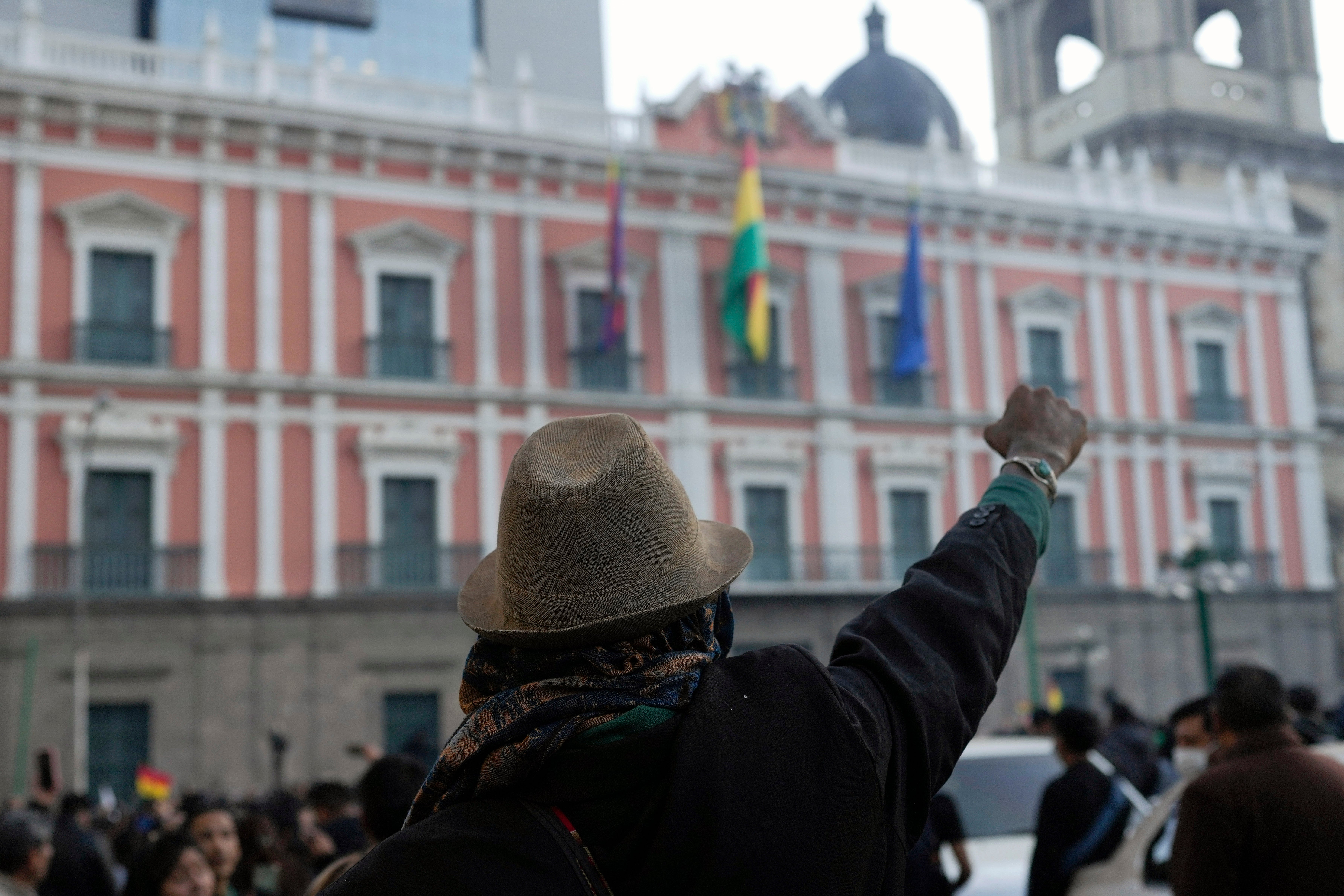 A supporter of Bolivian President Luis Arce raises a clenched fist in front of the government palace in Plaza Murillo, in La Paz, Bolivia, Wednesday, June 26, 2024