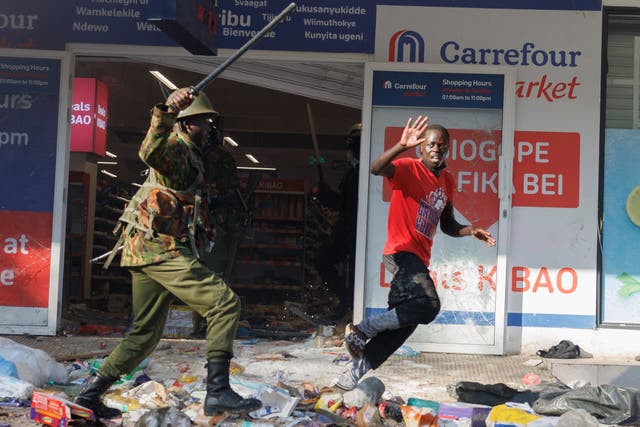 <p>A protester tries to escape from a policeman during a demonstration in Nairobi, on June 25, 2024</p>