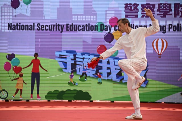<p>A man performs martial arts during a National Security Education Day programme in Hong Kong on 13 April 2024</p>