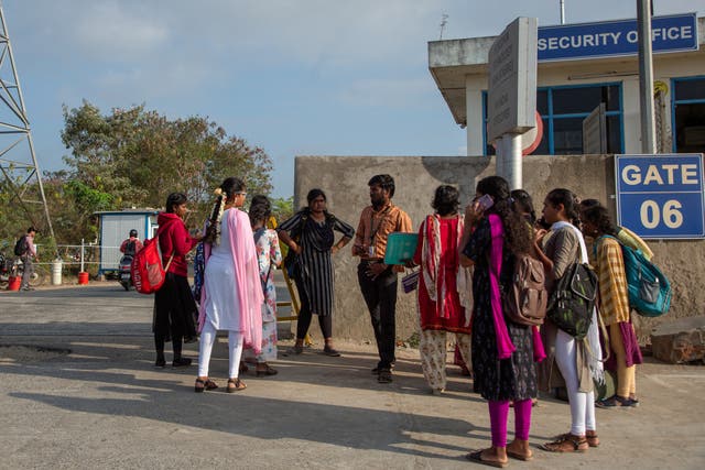 <p>Job aspirants talk to a hiring agent outside the Foxconn factory in Sriperumbudur near Chennai</p>