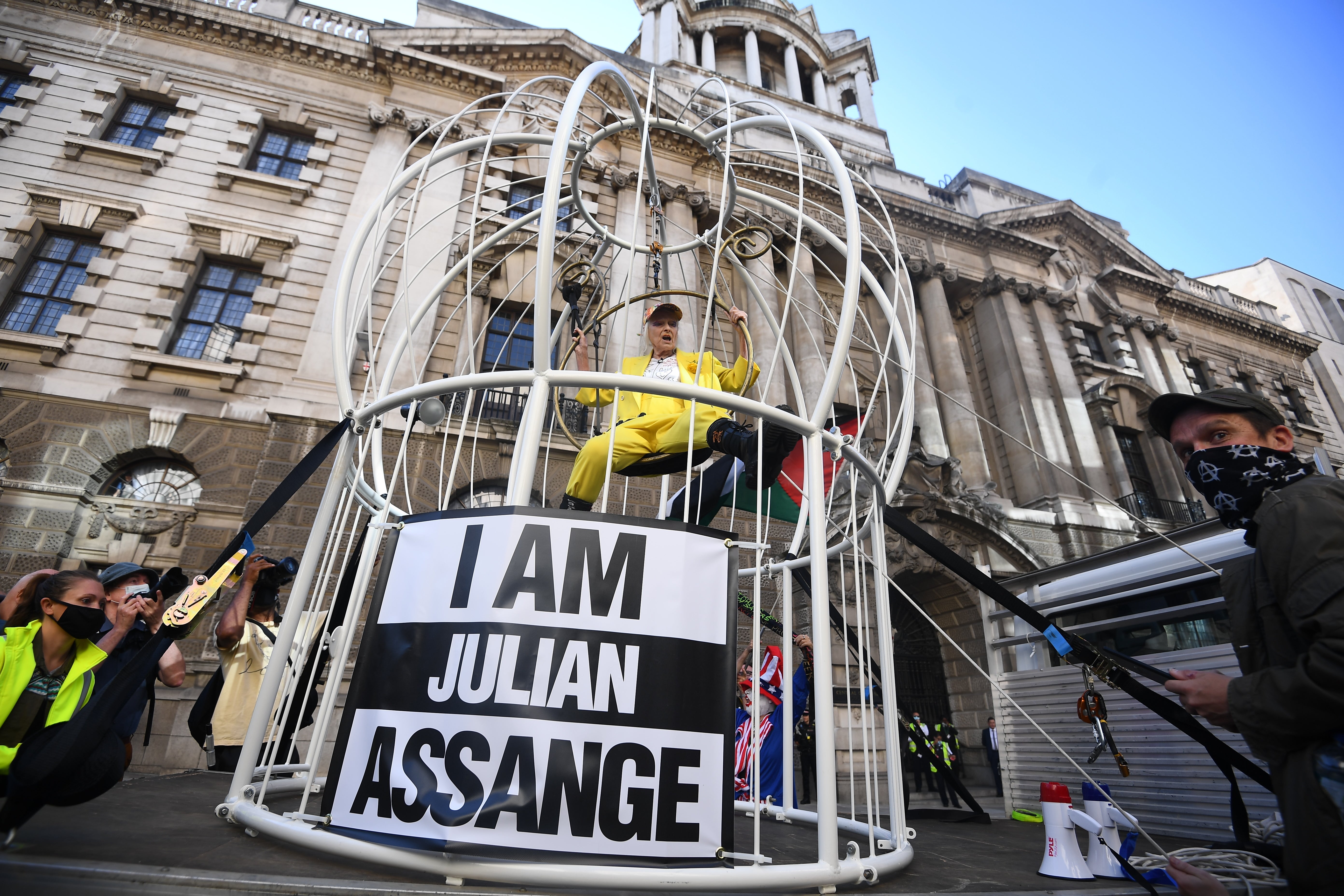 Julian Assange’s high-profile supporters included the late fashion designer Dame Vivienne Westwood, who was suspended in a 10ft high bird cage outside the Old Bailey in London to protest against his extradition (PA)