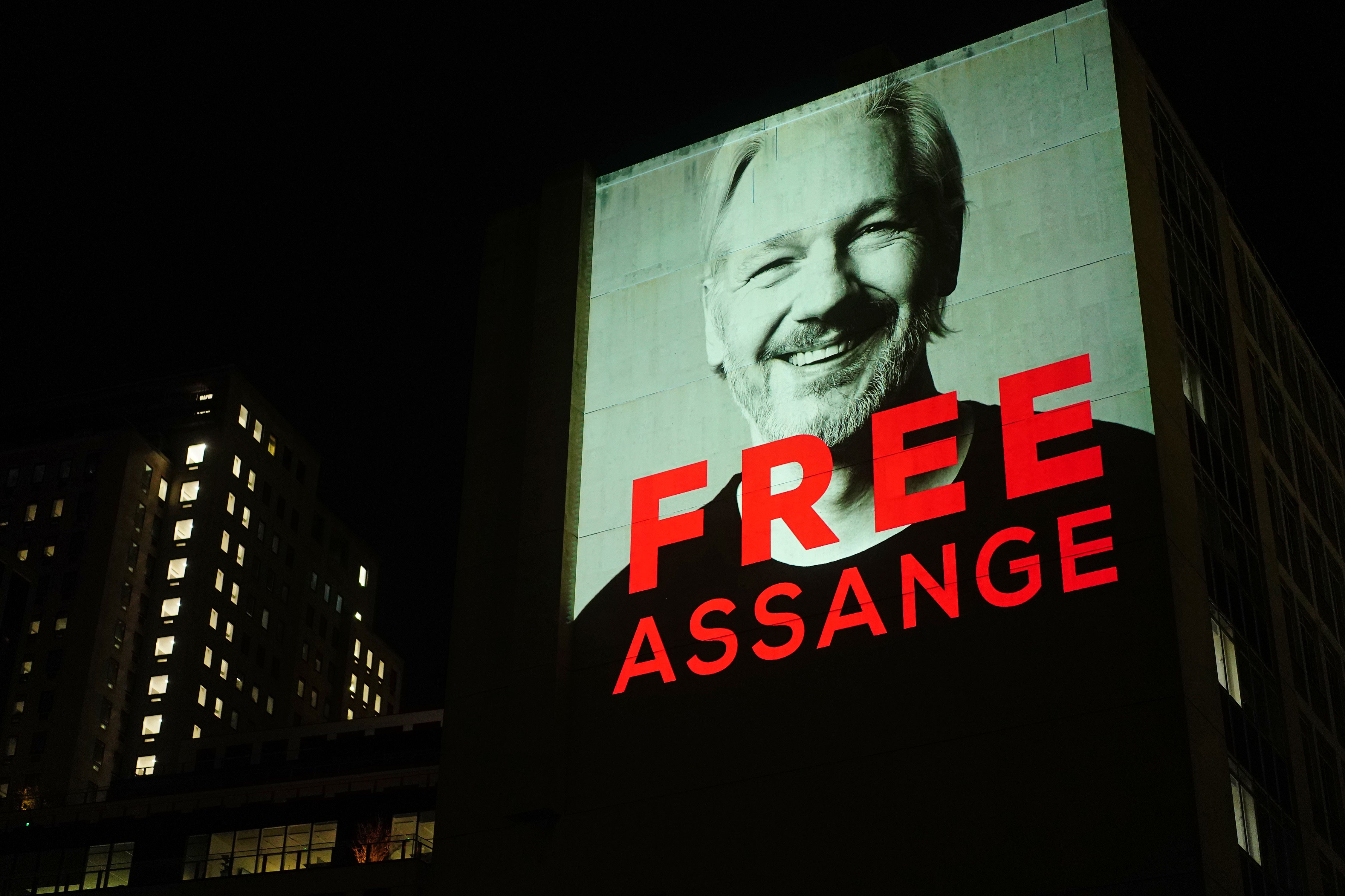 An image of Julian Assange is projected on to a building in Leake Street in central London in 2022 to mark three years since his arrest and detention in Belmarsh prison (PA)