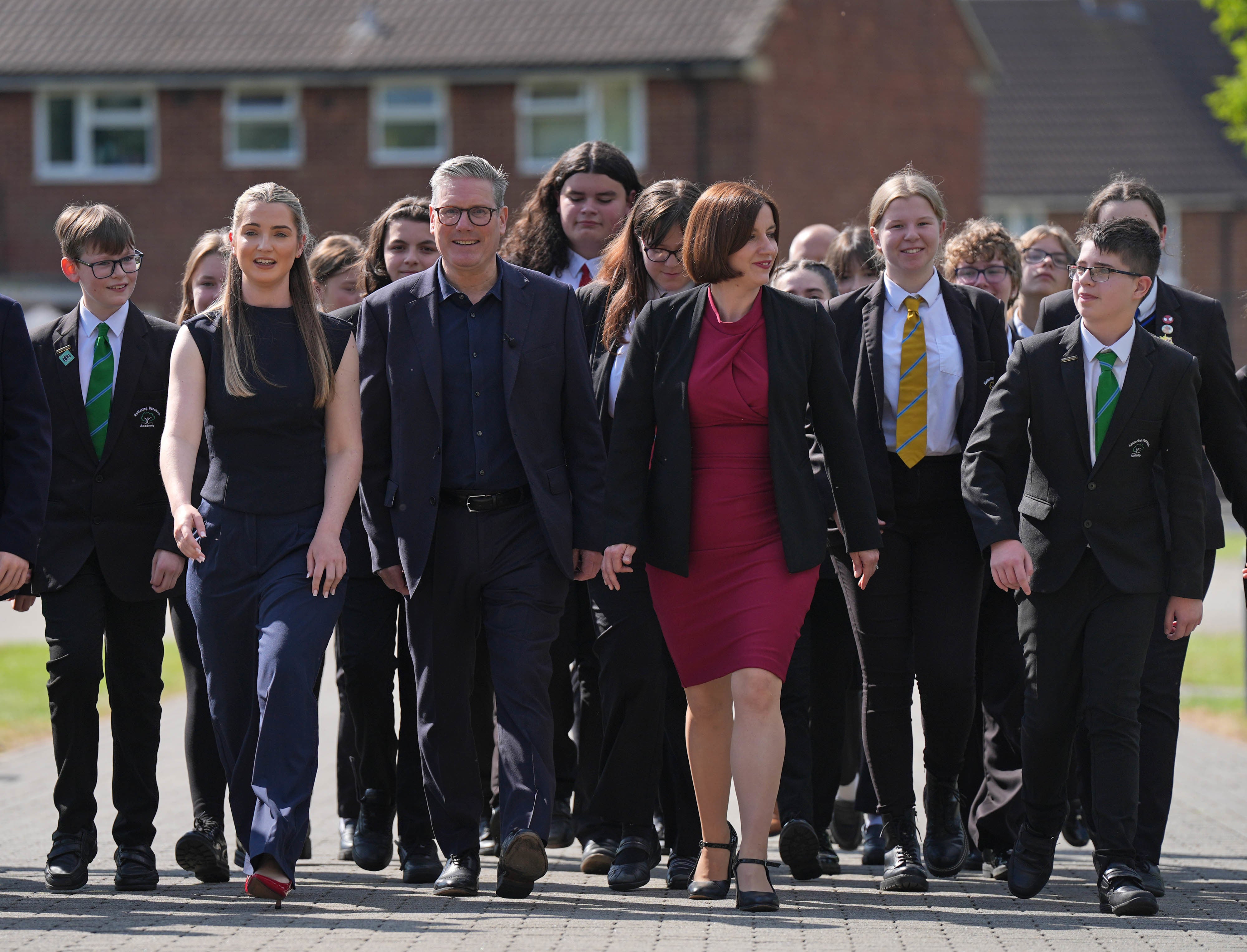 Labour Party leader Keir Starmer (centre) and shadow education secretary Bridget Phillipson (centre right) walk with pupils during a visit to a school in Northamptonshire