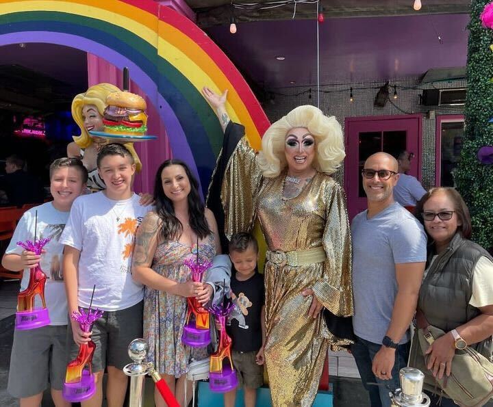 Sparkle Stone poses with her family at Hamburger Mary’s drag brunch