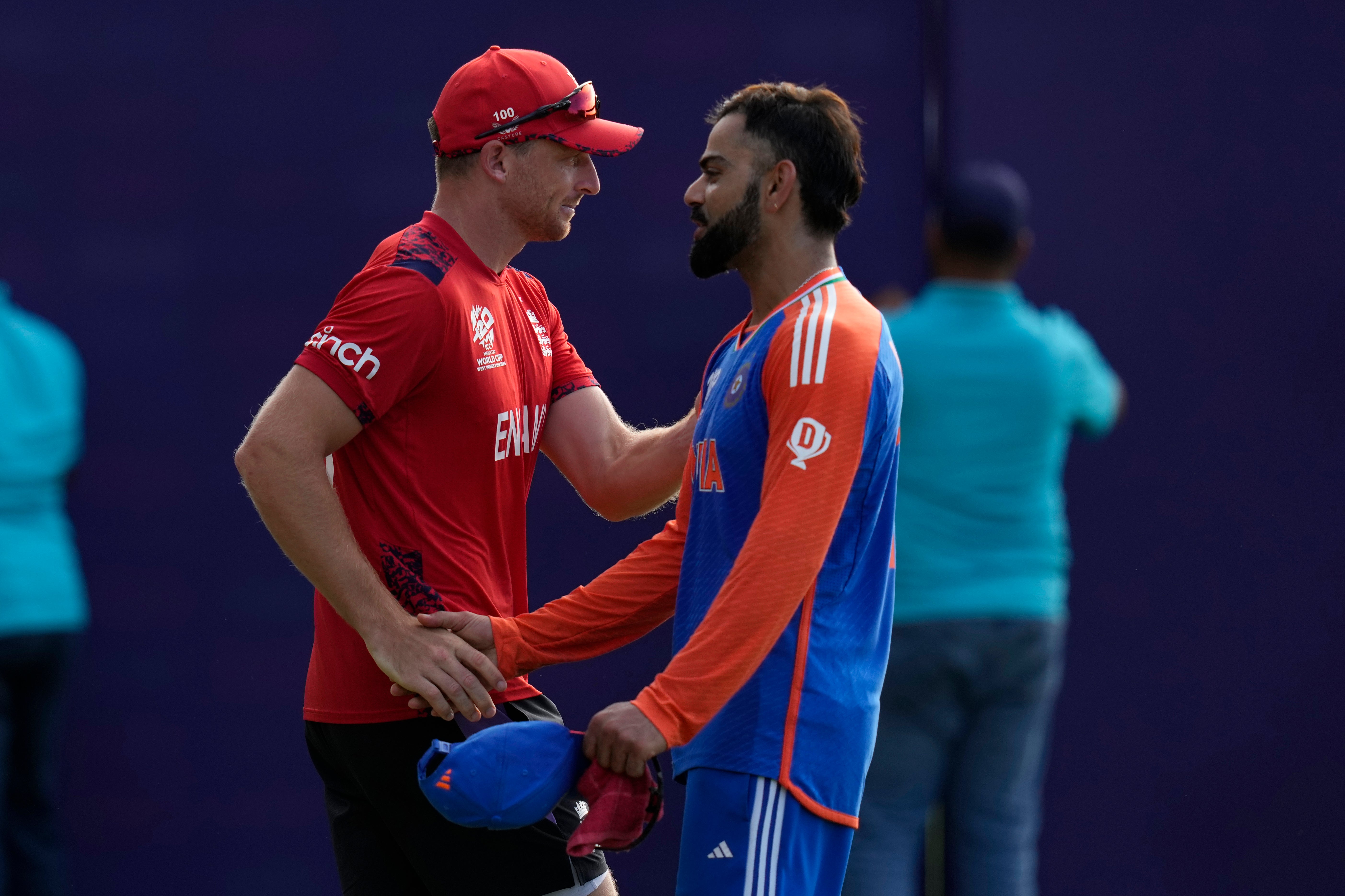 Virat Kohli, right, shakes hands with England’s captain Jos Buttler (Ramon Espinosa/AP)