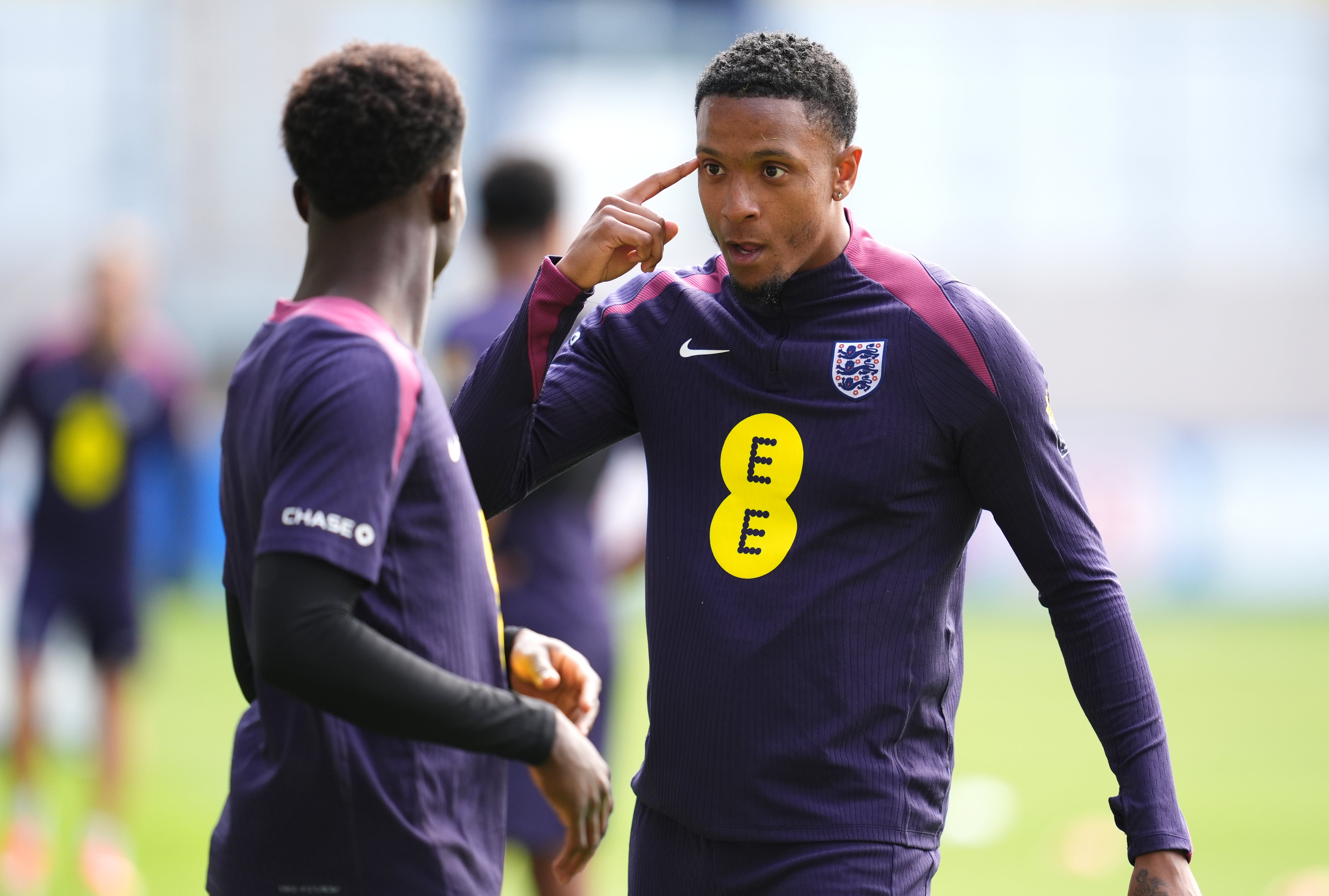 England’s Ezri Konsa, right, speaks to team-mate Bukayo Saka during a training session at the Ernst-Abbe-Sportfeld in Jena (Adam Davy/PA)