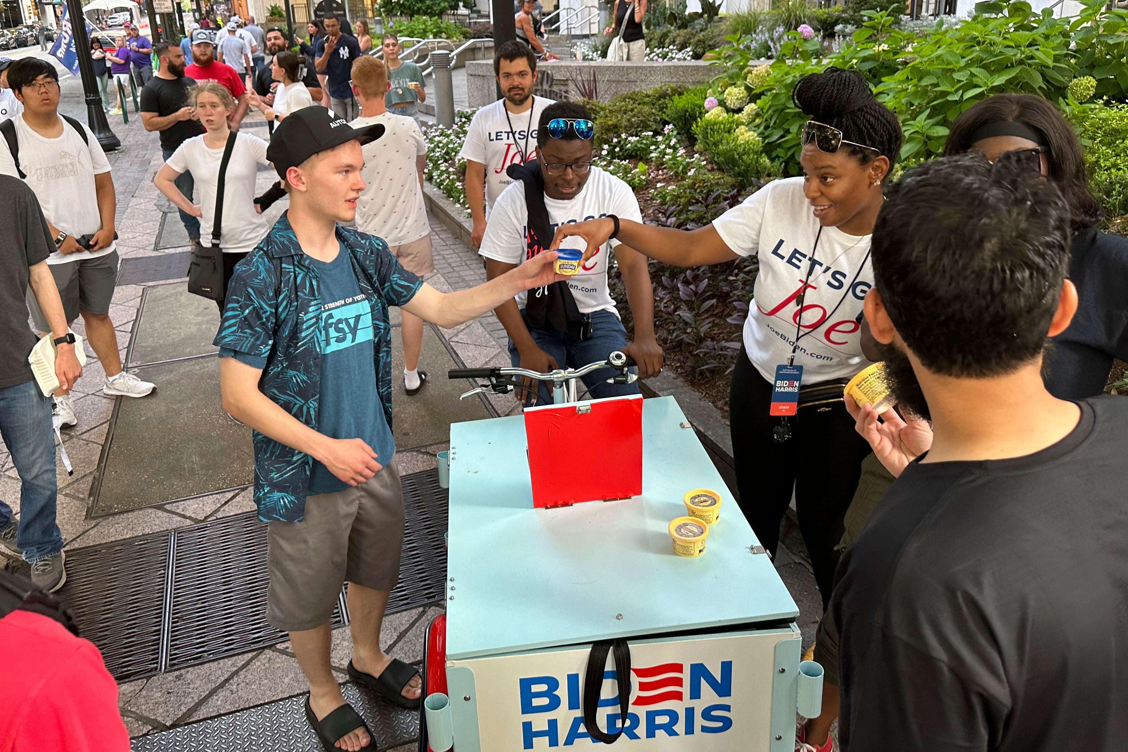Supporters of President Joe Biden distribute ice cream near his hotel