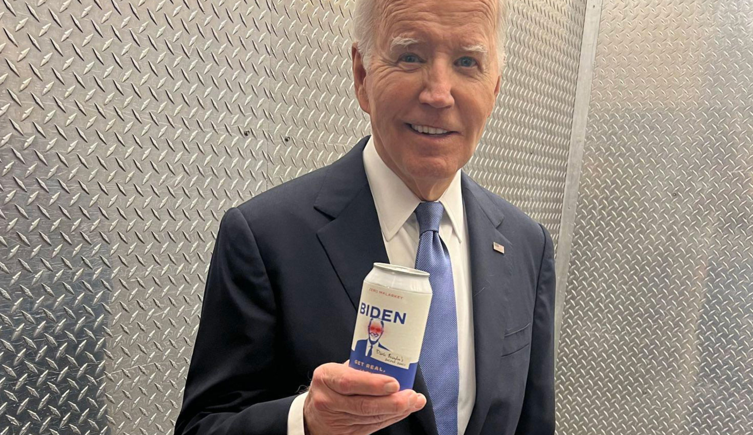 President Joe Biden poses with a can of water on June 27 mocking Donald Trump’s unsubstantiated claims that the president is using performance-enhancing drugs