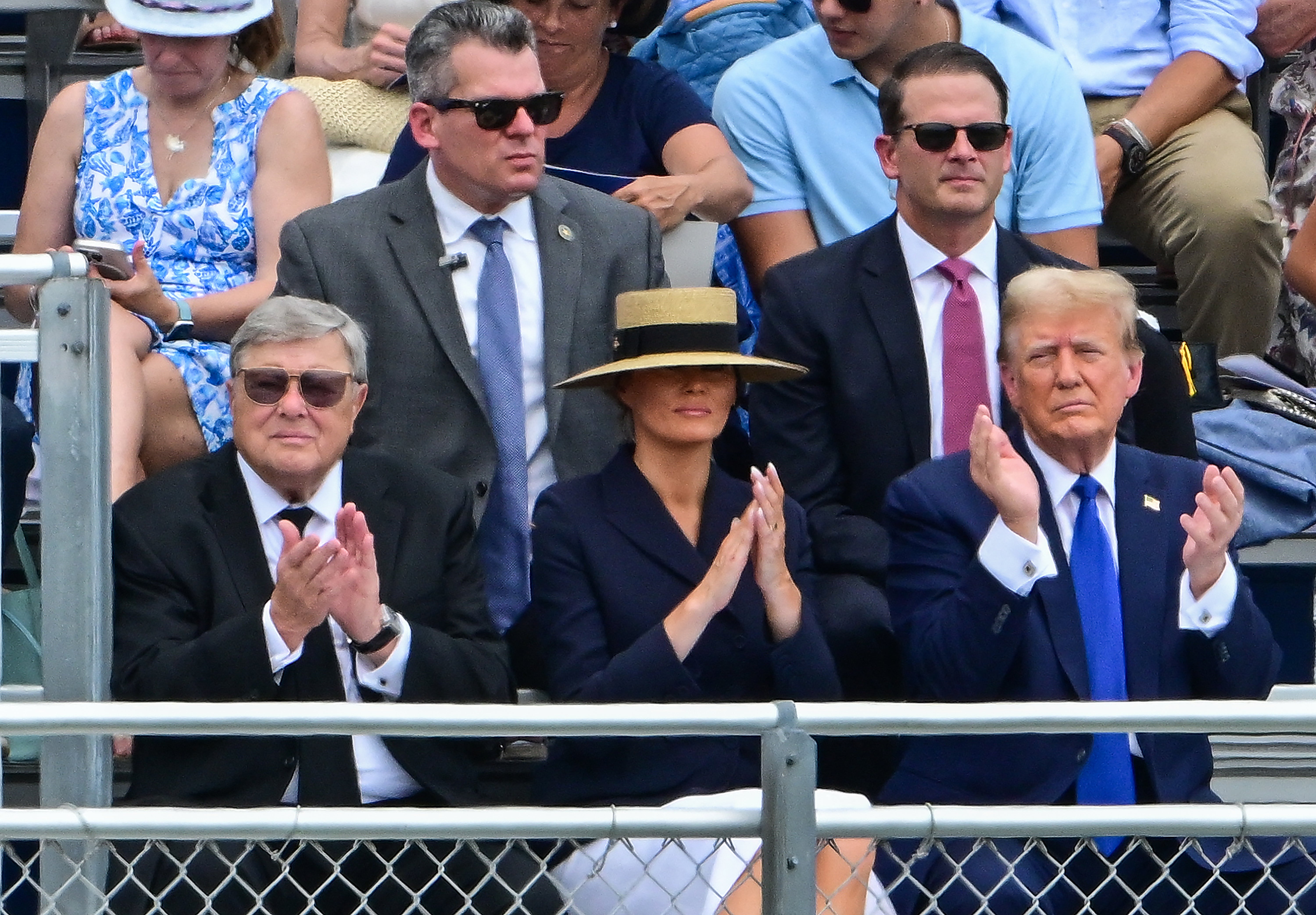 Donald Trump (right), Melania Trump (center) and her father Viktor Knavs (left) attend Barron Trump’s high school graduation. Experts say Melania is distancing herself from her husband