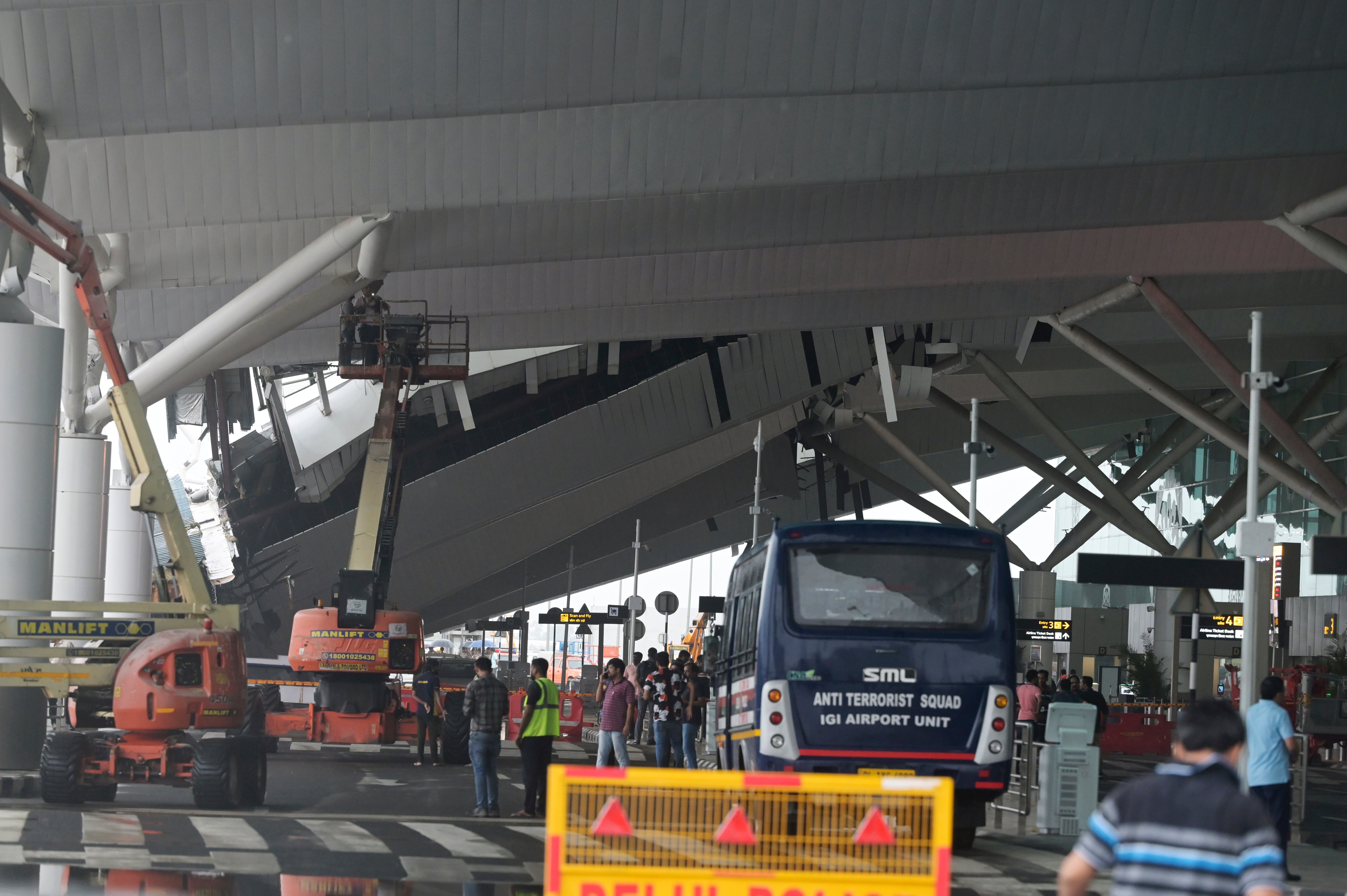 A crew inspects the damage to a part of a departure terminal canopy at New Delhi’s Indira Gandhi International Airport that collapsed in heavy pre-monsoon rains in New Delhi, India, Friday, 28 June 2024