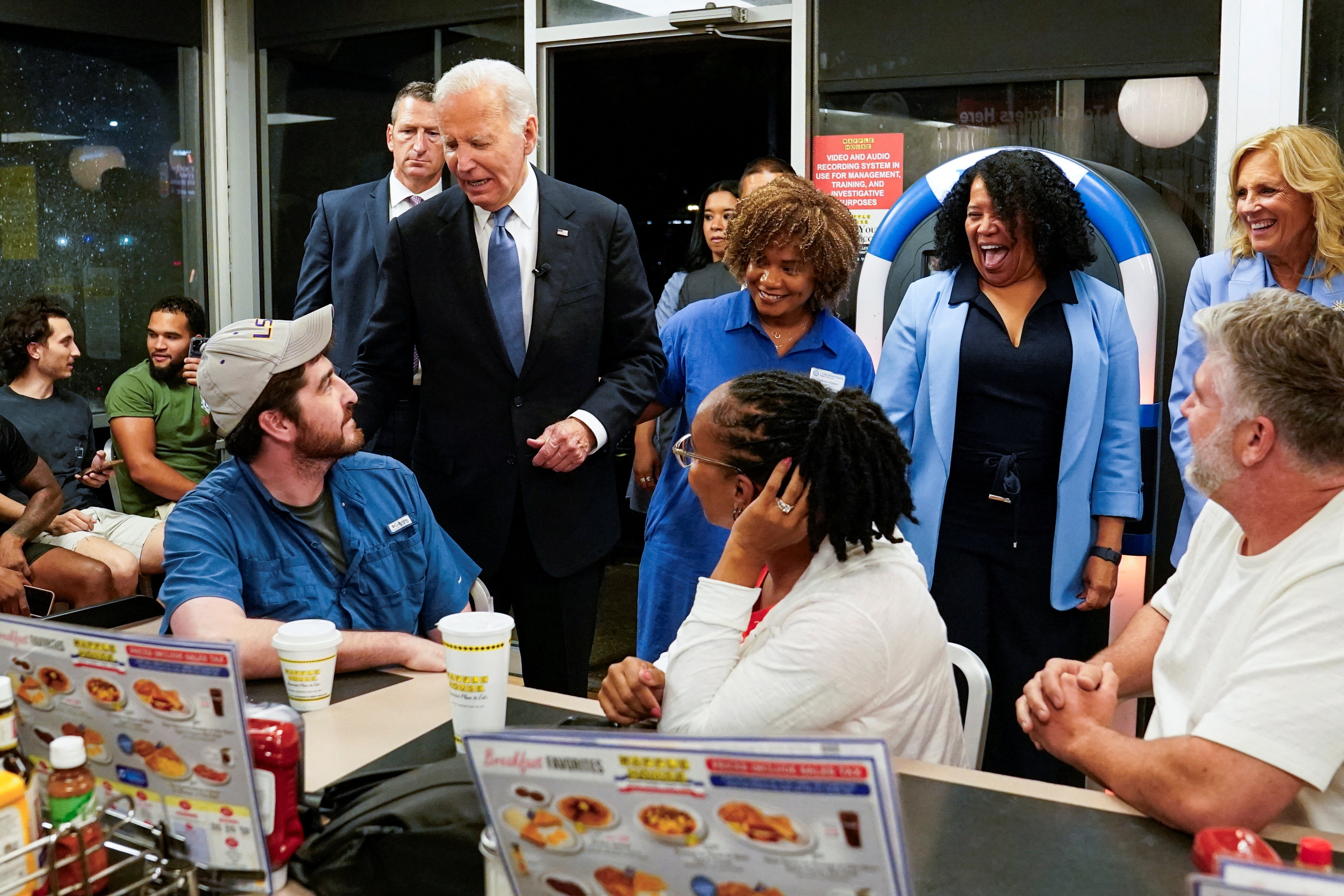 President Joe Biden greets people as he and First Lady Jill Biden pick up an order from a Waffle House in Marietta, Georgia