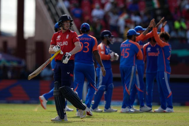 England’s Harry Brook, left, walks off the field after losing his wicket during the ICC Men’s T20 World Cup second semifinal cricket match between England and India (Ramon Espinosa/AP)