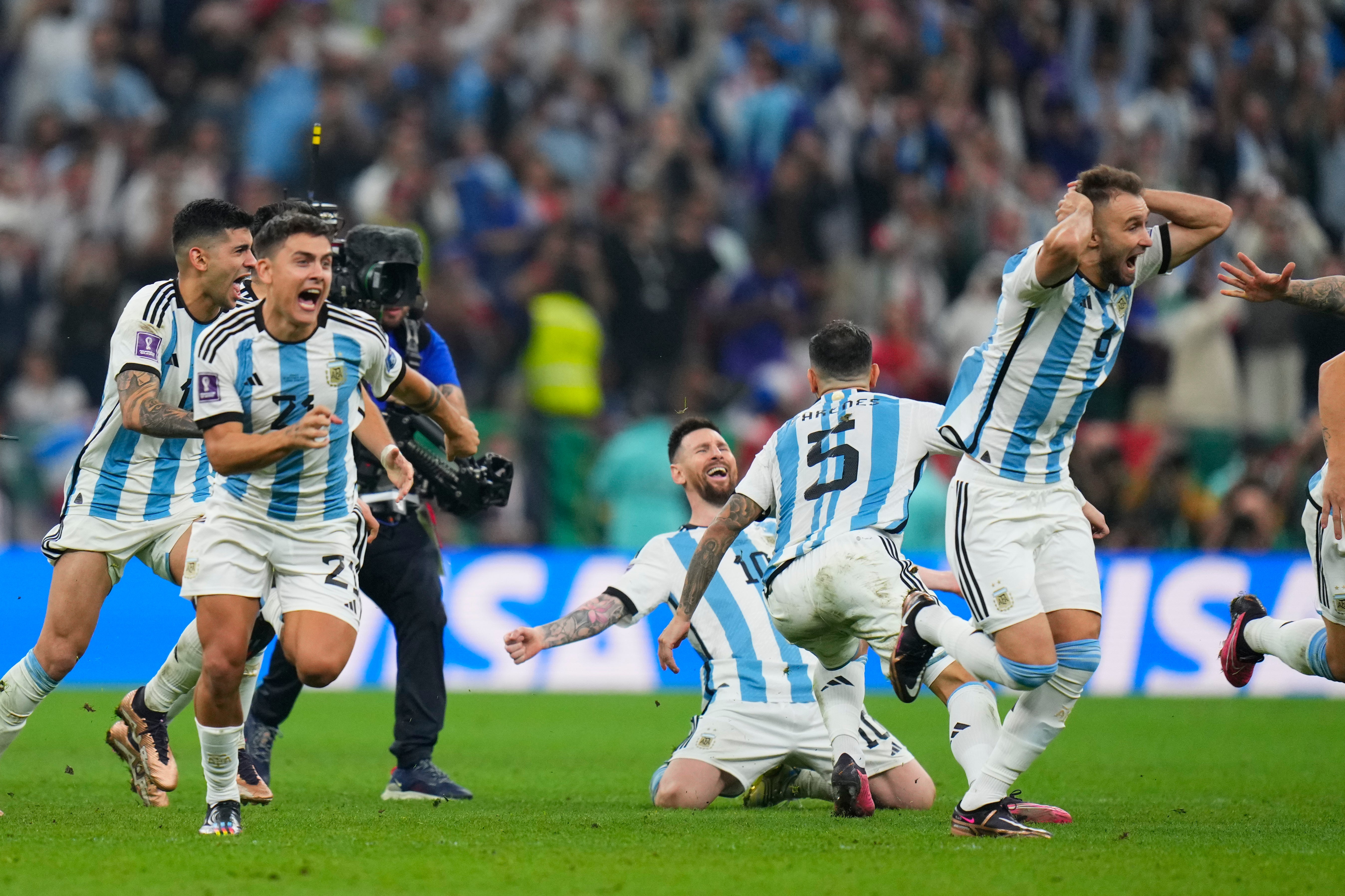 Argentinian players celebrate after winning the World Cup final penalty shootout in Doha