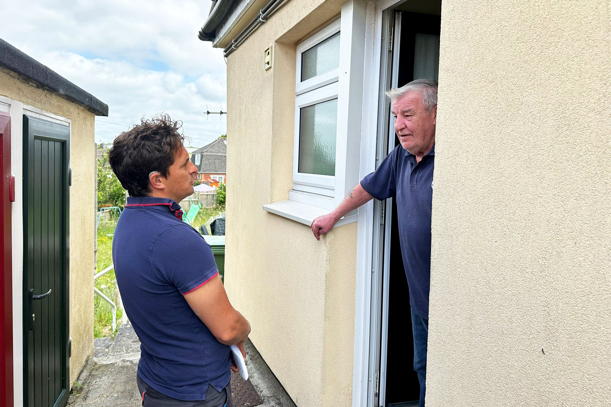 Johnny Mercer speaks at the door of one Conservative voter who picks up the issue on grass cutting
