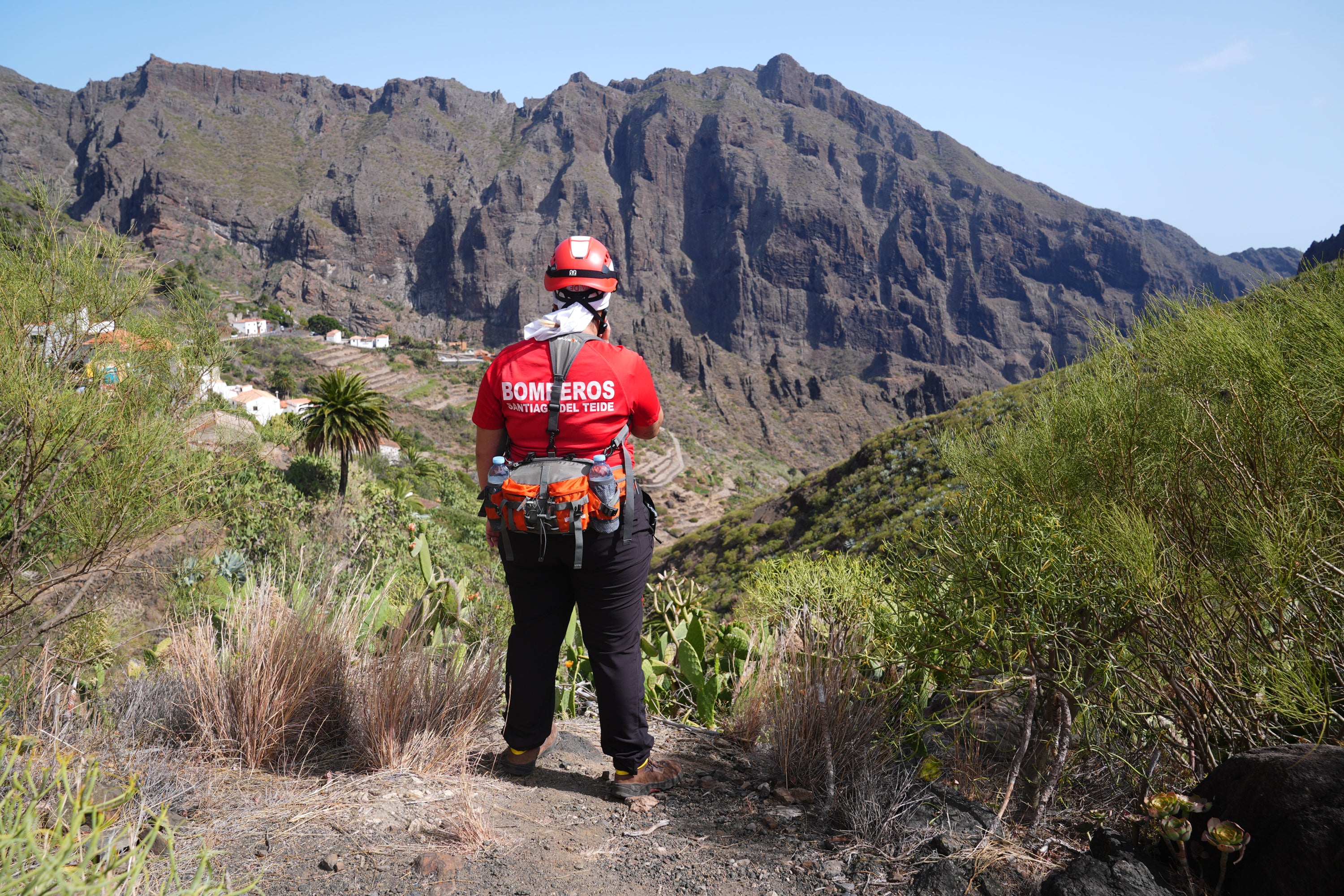 A firefighter looks over the village of Masca, Tenerife, while the search is ongoing (James Manning/PA)